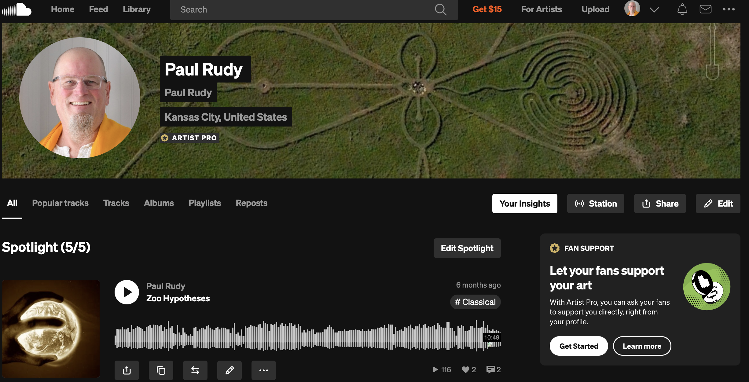 Satellite image of a labyrinth park in Kansas City, with a maze shaped like an angel with outstretched wings, surrounded by green grass.
