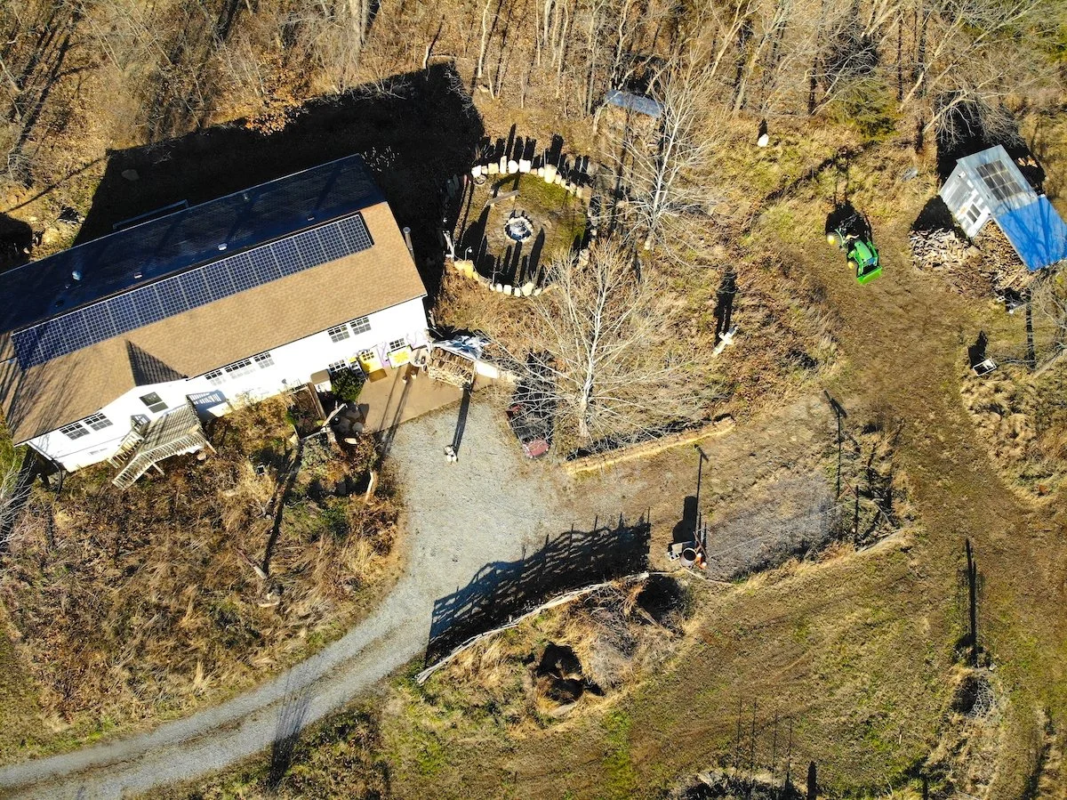 Drone image of the house at Harmony Farm and the Sun Temple stone circle east of it with late day winter long shadows