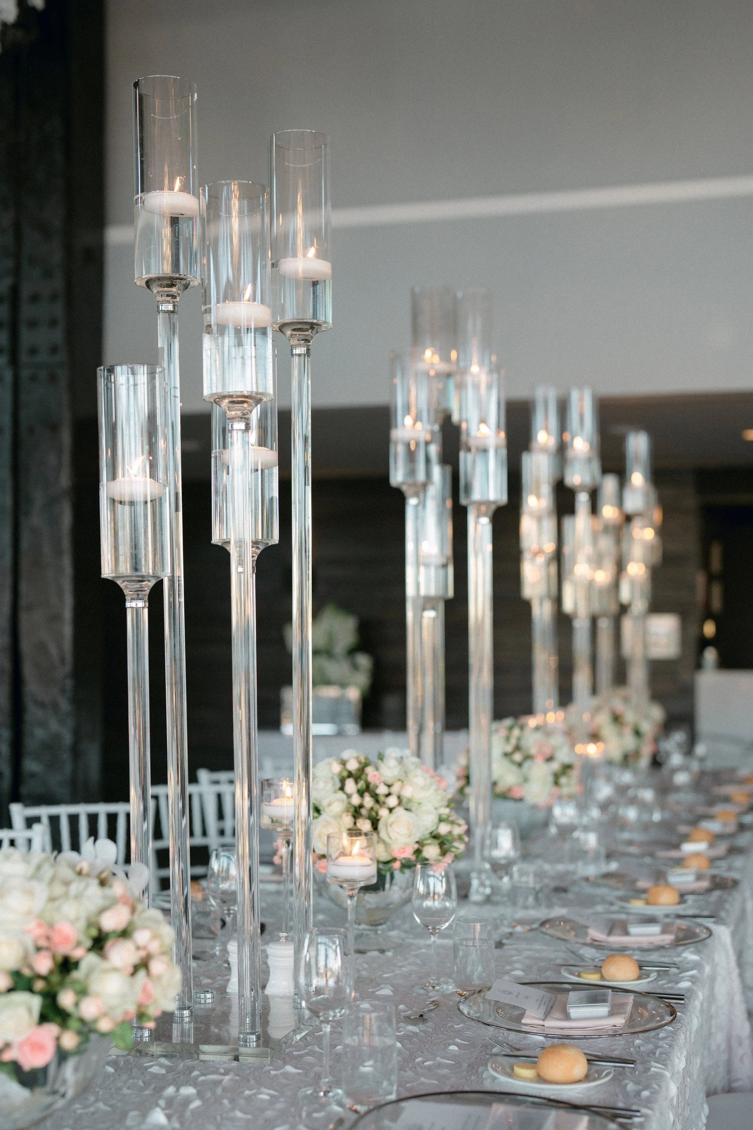 Opulent wedding tablescape with crystal candelabras and floating candles.
