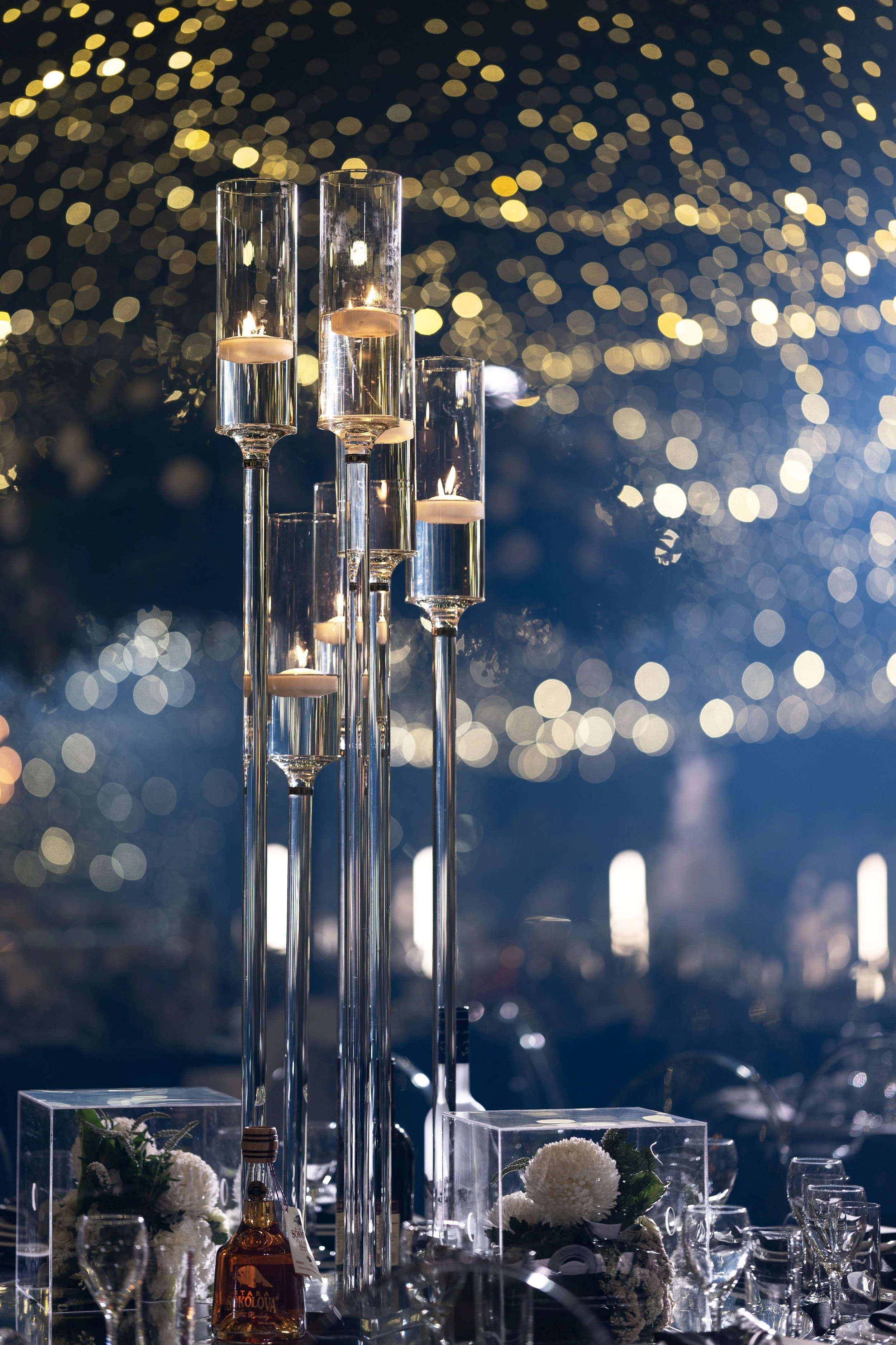 Luxury reception styling featuring opulent candelabras with floating candles