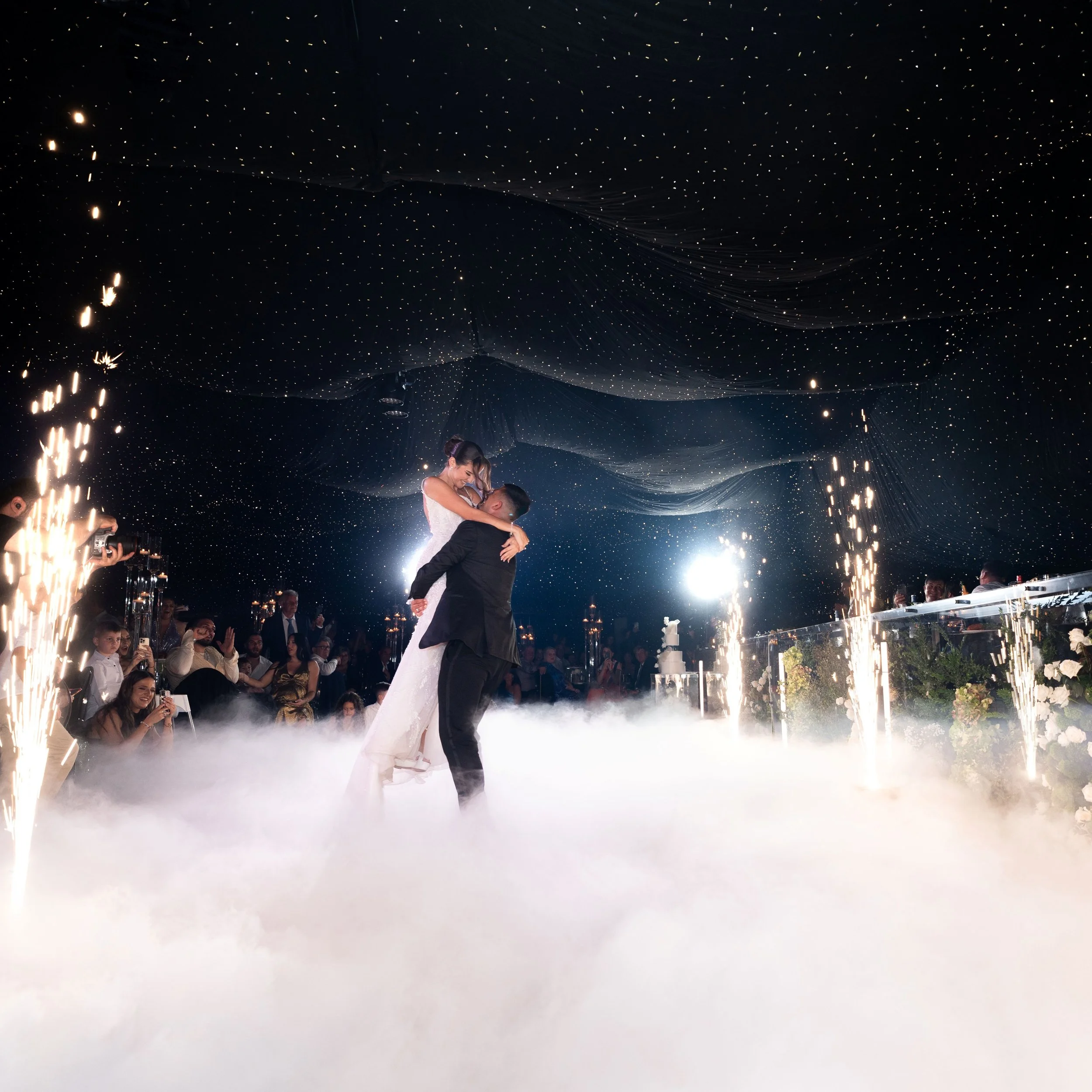 Bride and groom first dance with fireworks and dry ice dancefloor
