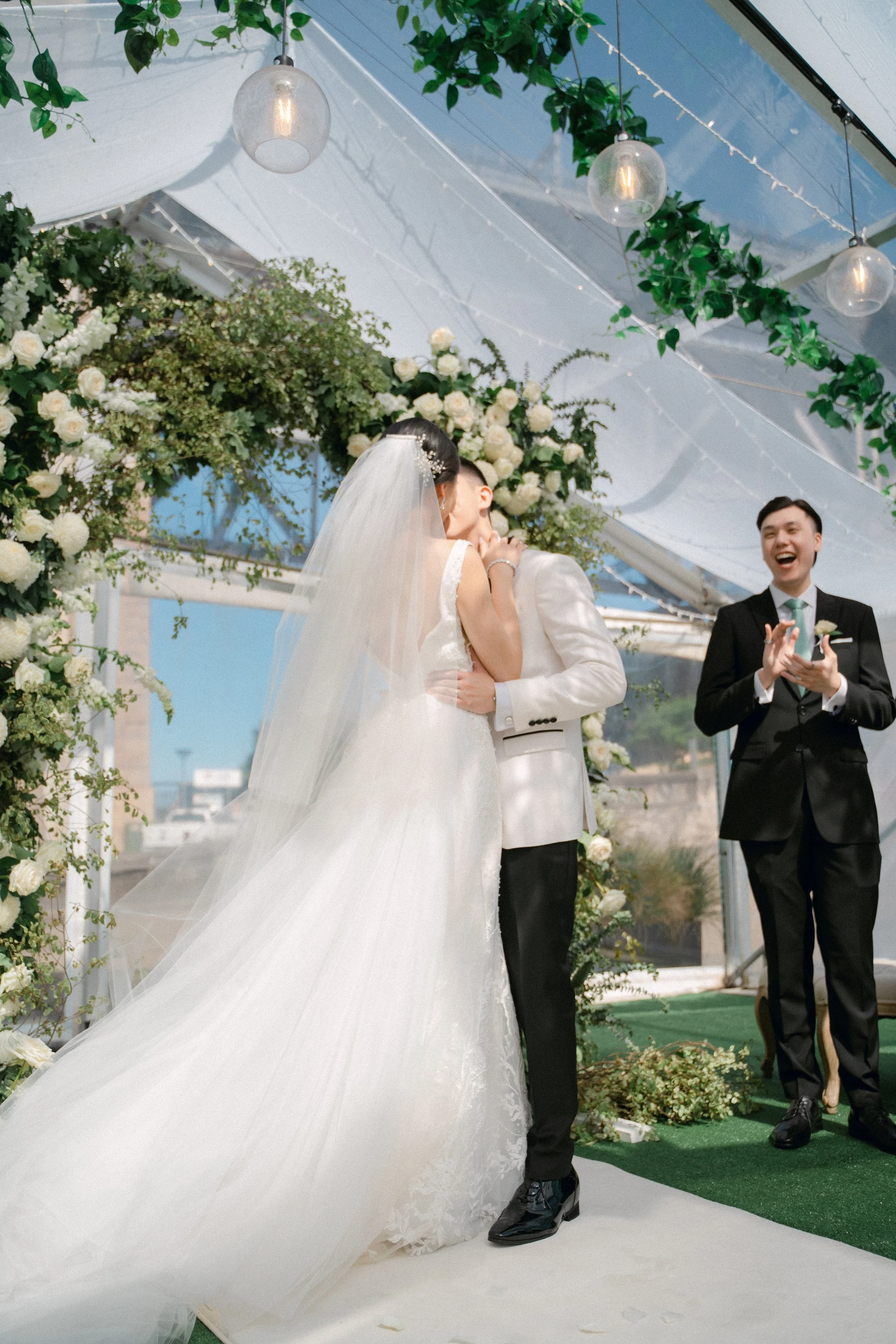 Bride and groom share their first kiss under marquee during their sydney harbour ceremony