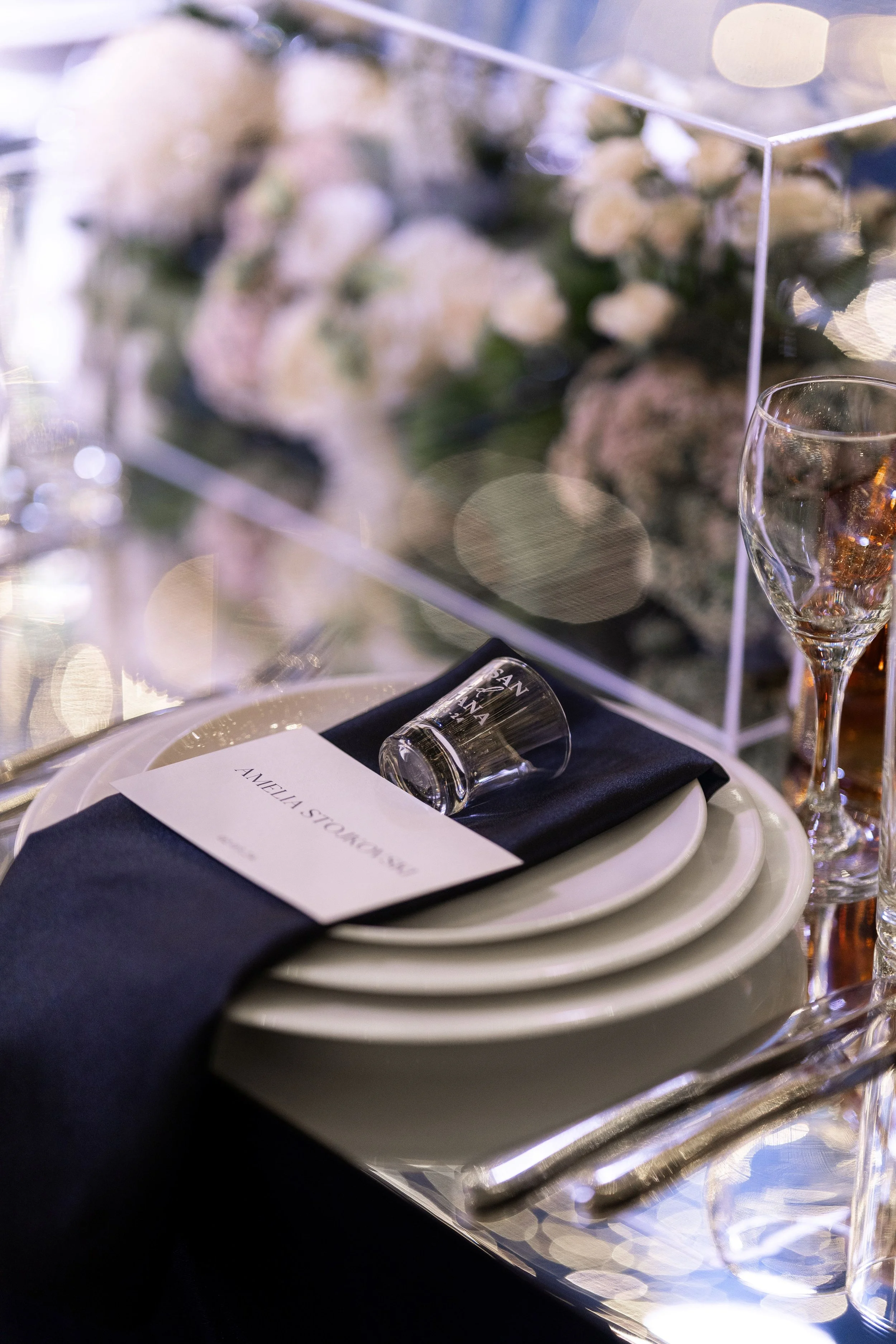 Luxury Sydney wedding with crystal glassware, white florals and candlelit table decor.