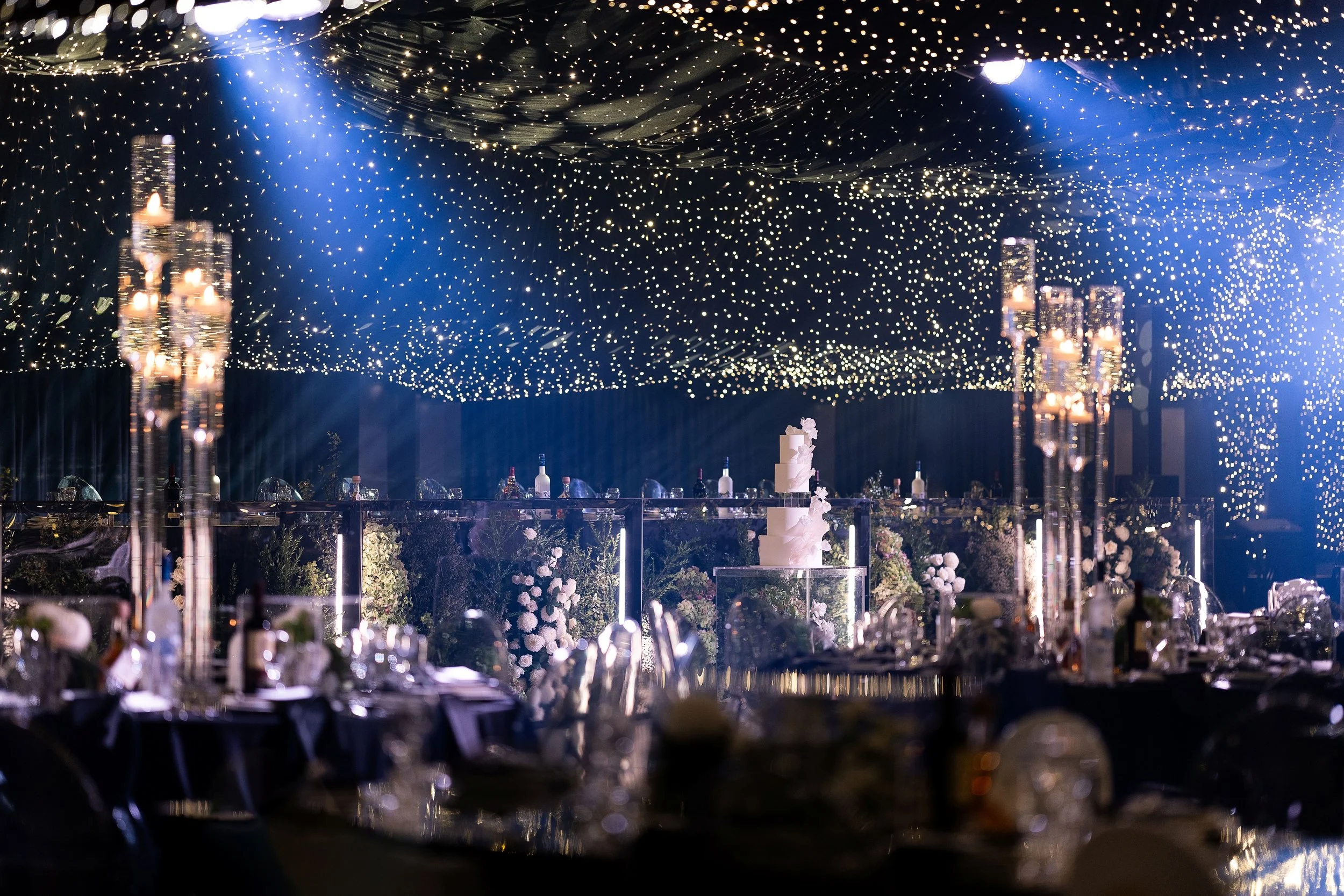 Elegant wedding reception tables with glowing candles