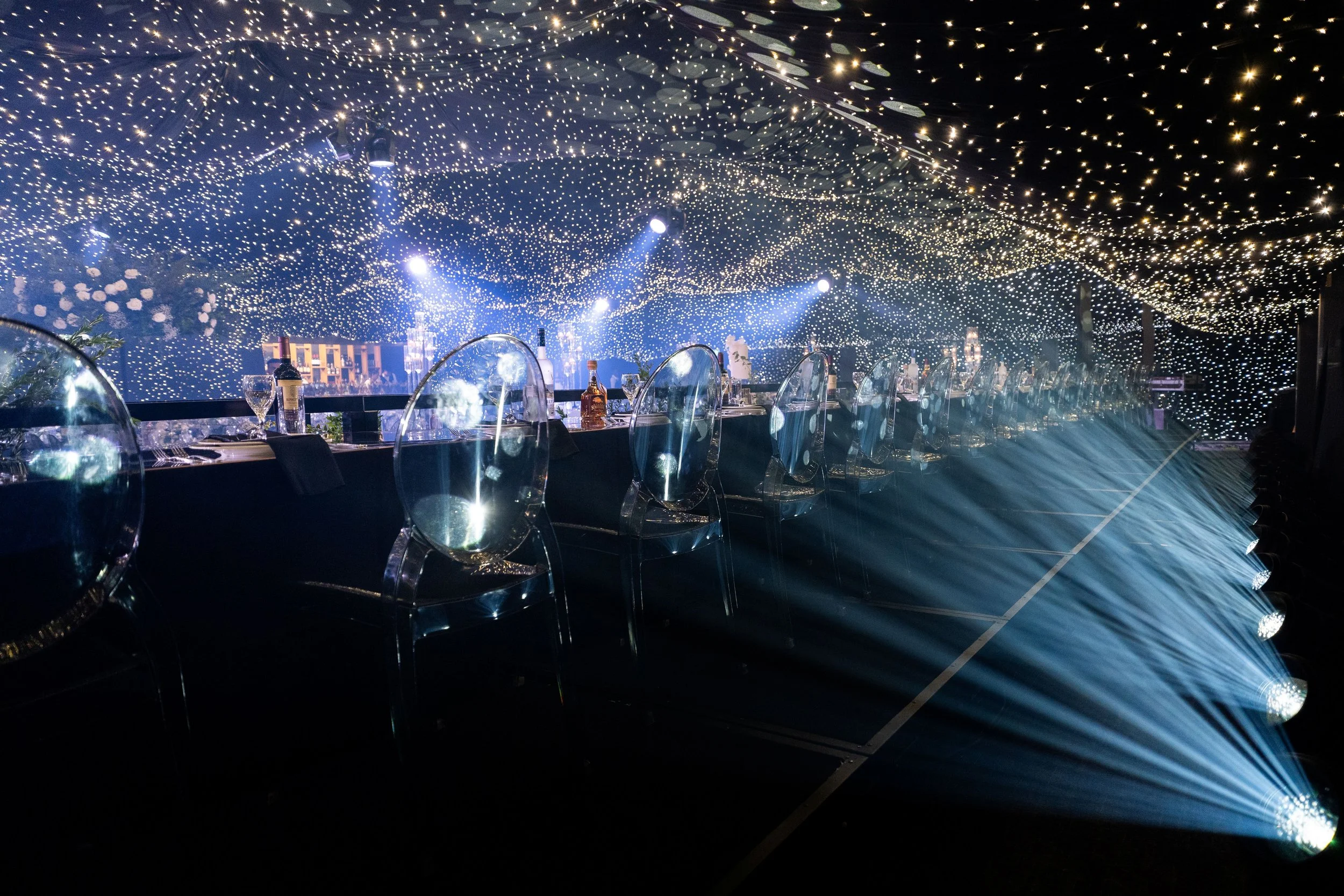 Grand bridal table with ghost chairs and starry backdrop