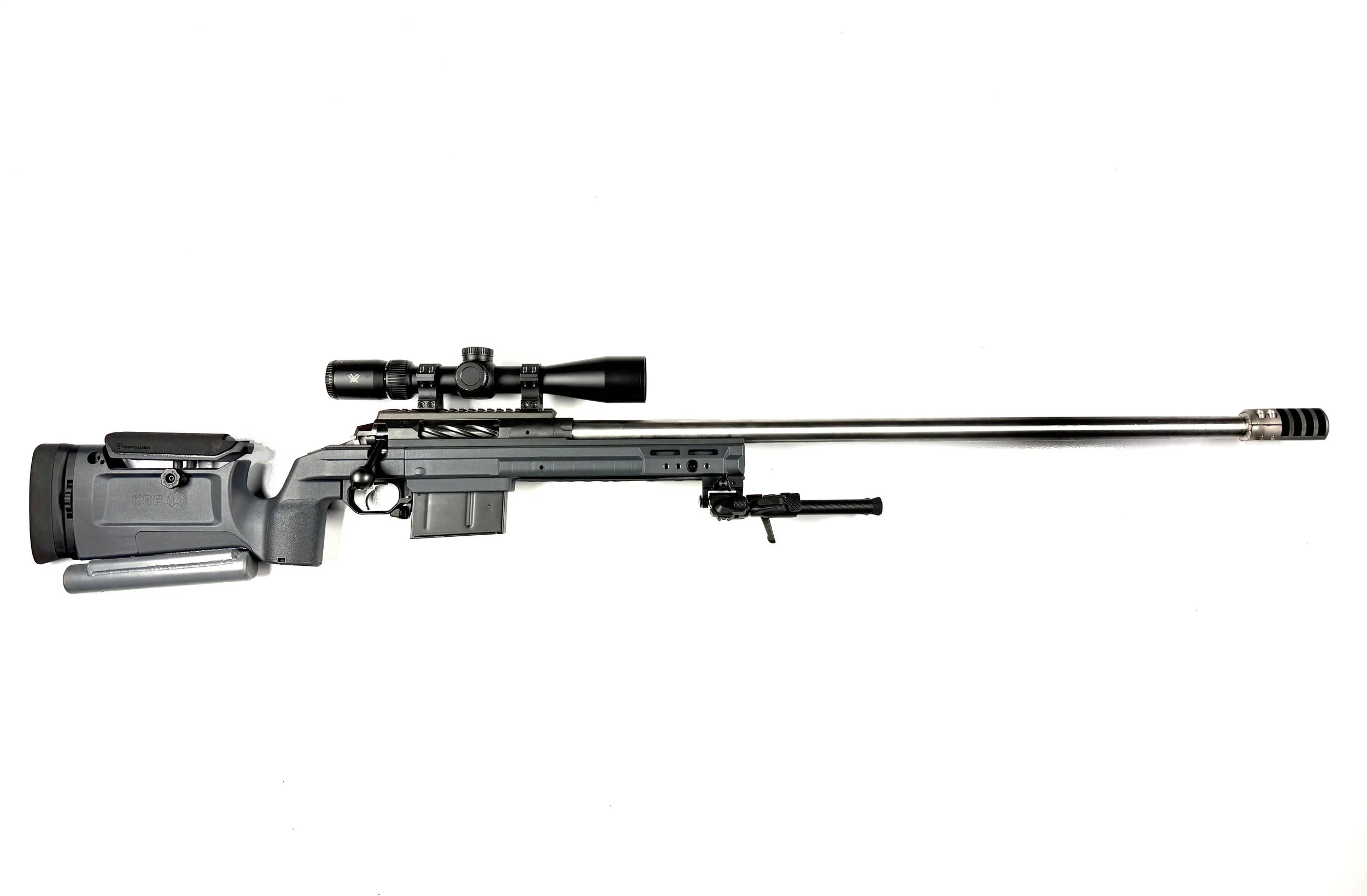 A precision rifle with a scope and high-tech stock, isolated on a white background.