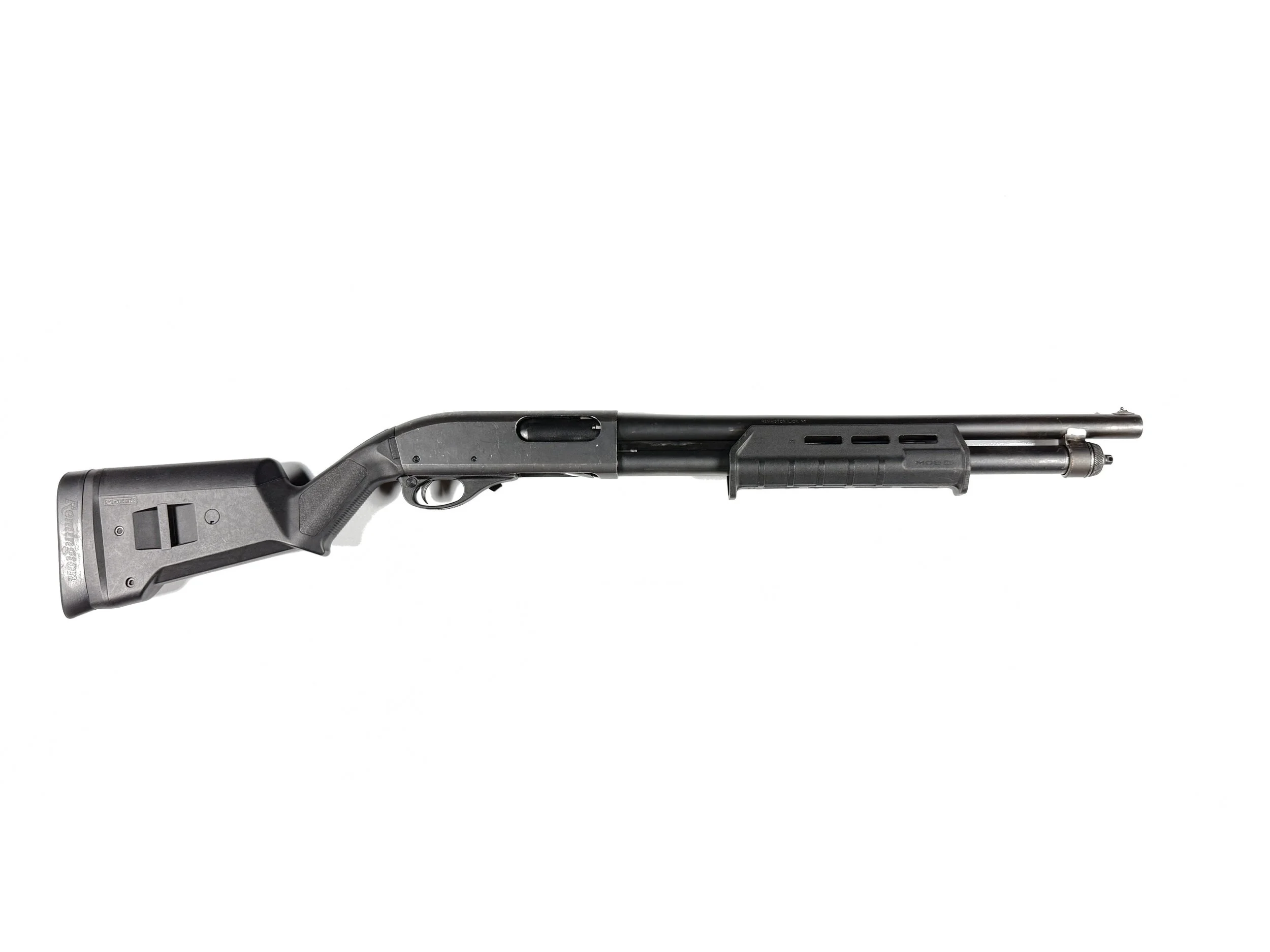 Black shotgun with a stock and a long barrel, isolated on a white background.