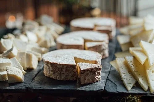 Cheese wheels lined up for serving
