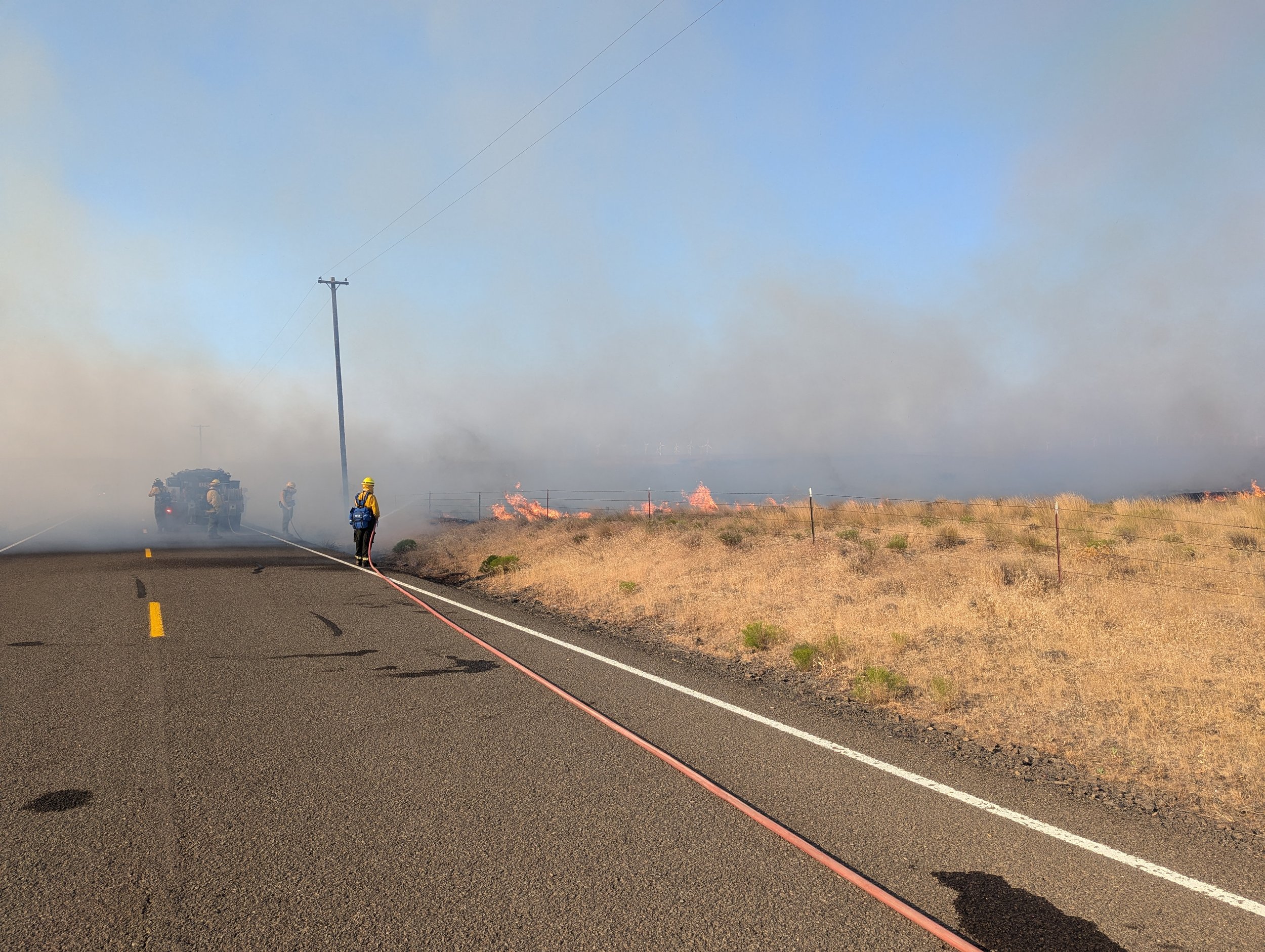 Volunteer Wright during a "pump and roll" maneuver, trying to hold the fire line at the road. Bighorn Fire, July 25, 2024