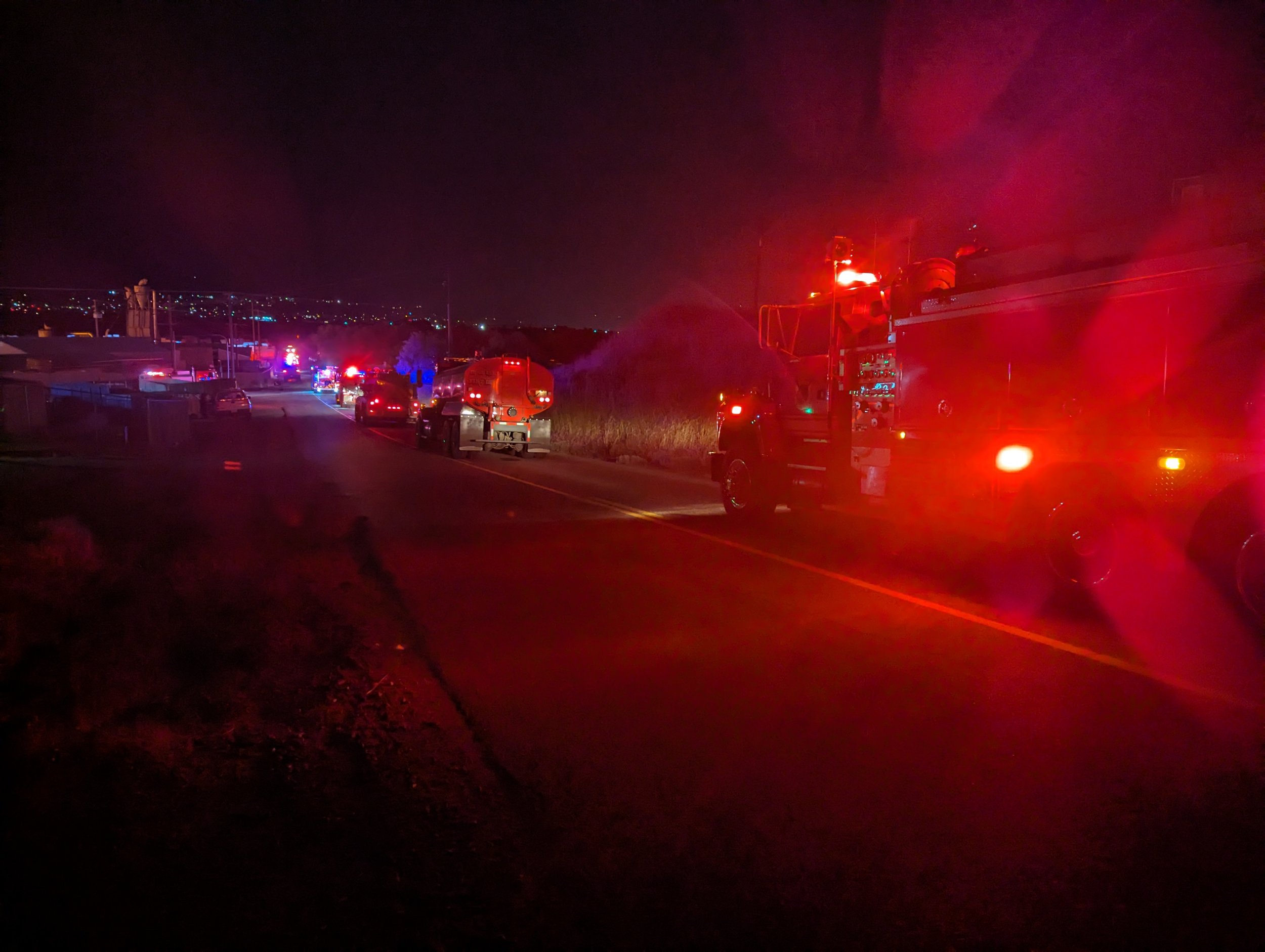 A long line of water tenders hauling water for fire suppression efforts. Tidyman Road Fire, May 17, 2024