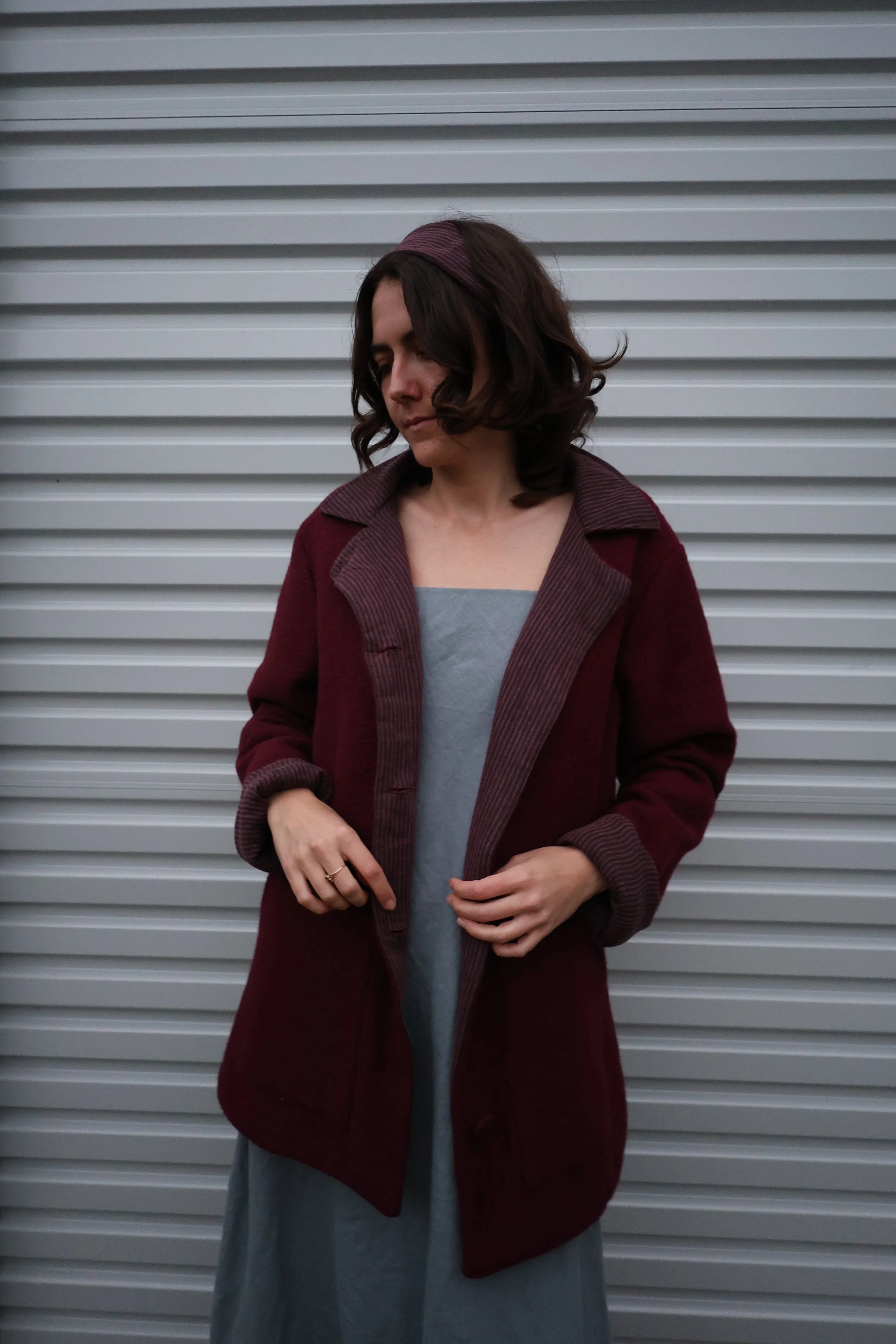 A handmade in Australia wool coat with contrast lining and features.