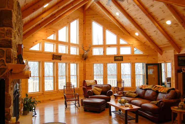 Henry custom log home exterior with stone chimney