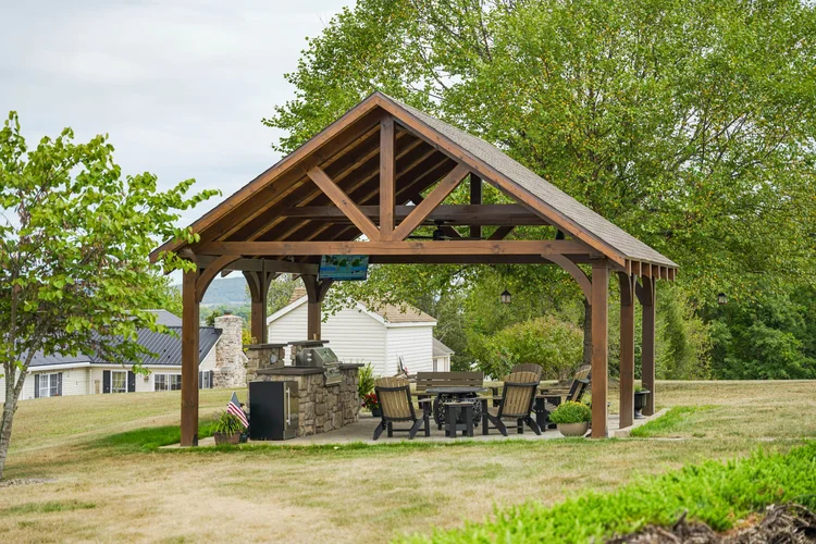 Wide view of timber-frame pavilion on residential property