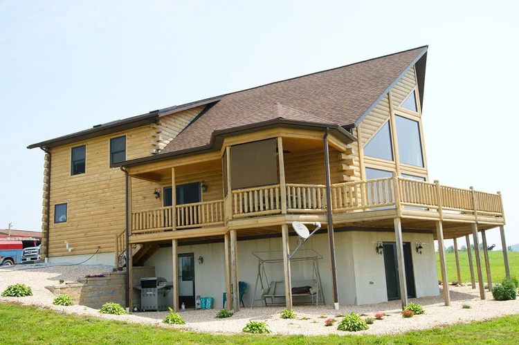 Aldinger log home side view with attached garage