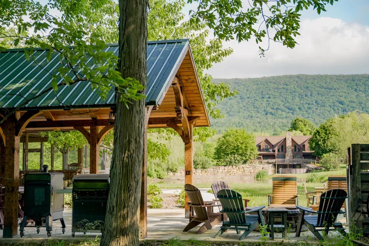 Timber pavilion with stone column bases and landscaping