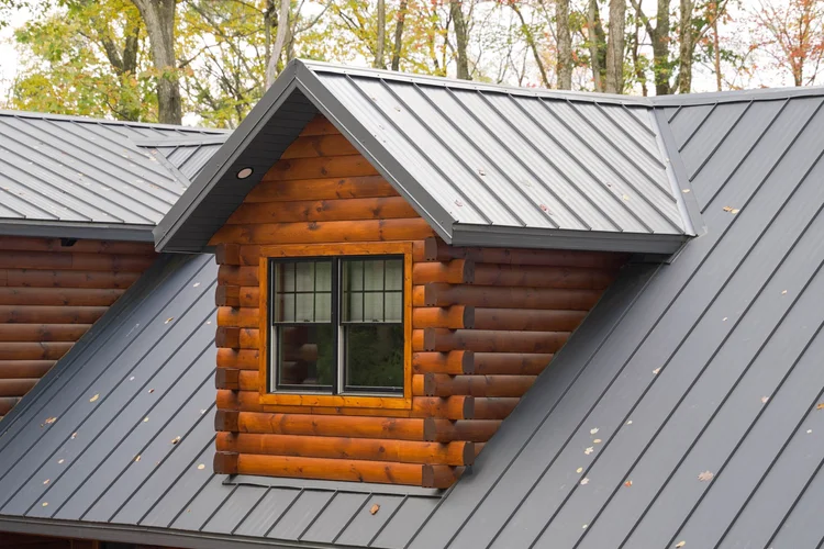 Rear view of custom log home showing deck and walk-out basement
