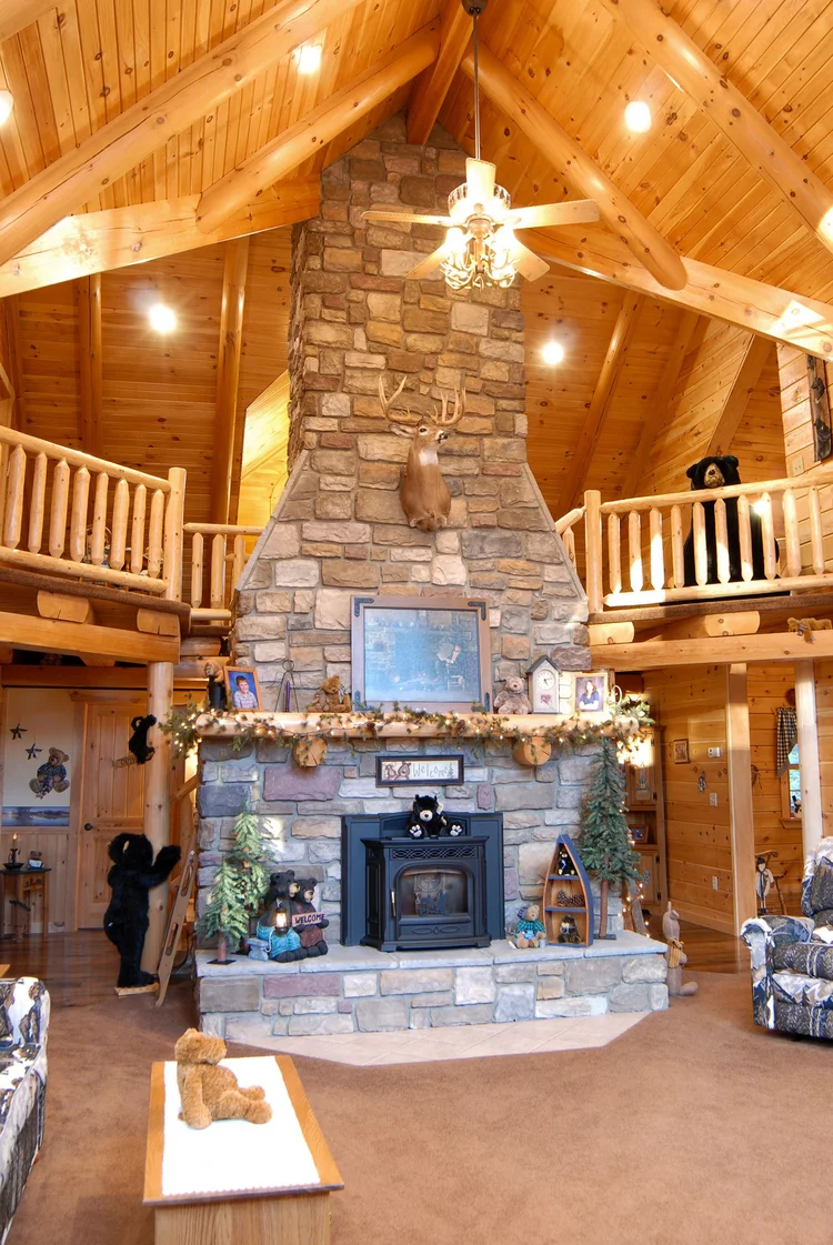Hicks log home with wraparound porch and dormers