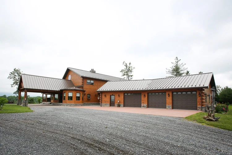 Attached three-car log garage with matching siding