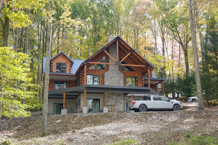 Log home front porch with handcrafted railing detail
