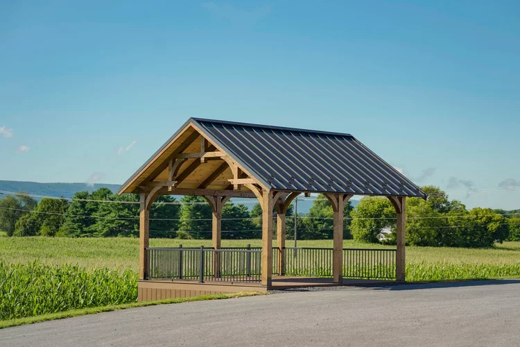Custom timber-frame pavilion with stone base and outdoor kitchen
