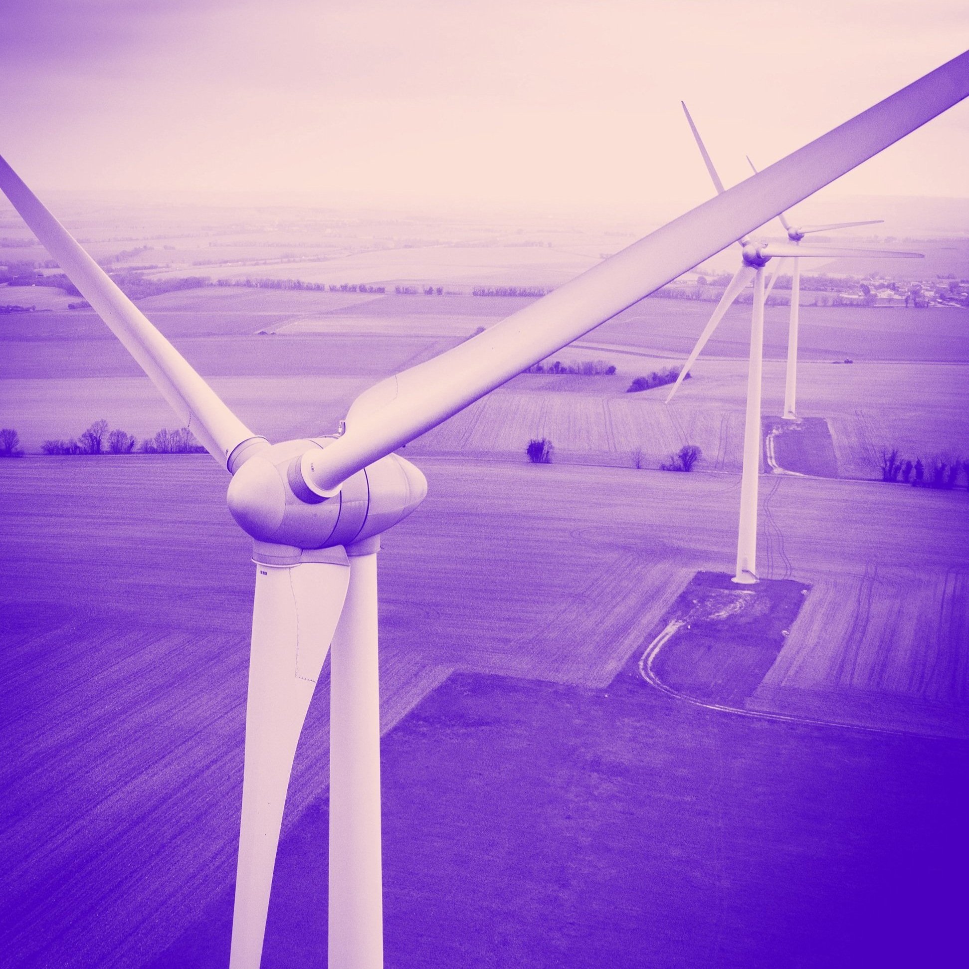 Image of large windmills across farmland