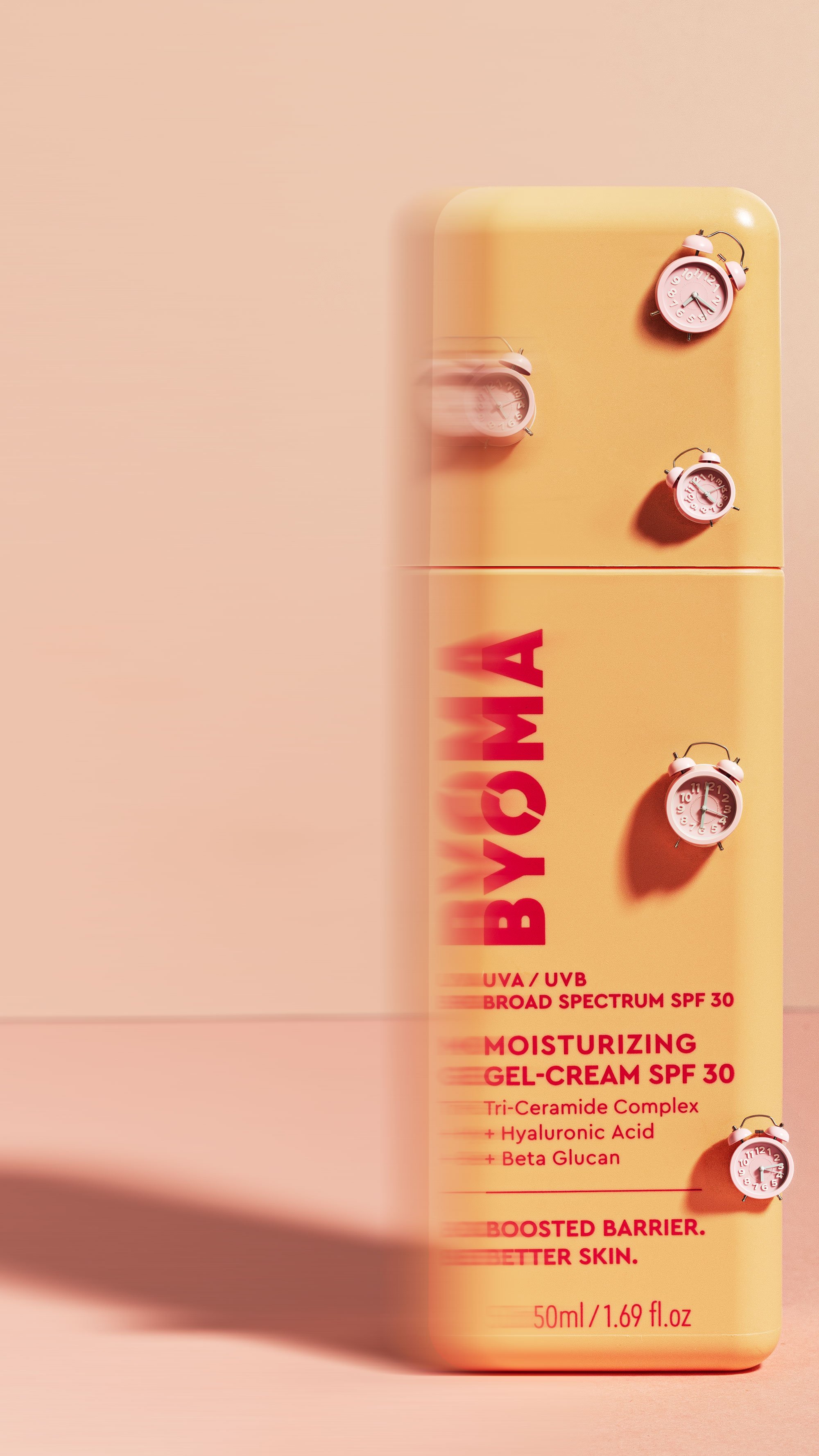 A byoma moisturizing gel cream spf 30  with pink alarm clock figurines attached, displaying information about UV protection, broad spectrum SPF 30, moisturizing gel-cream, and ingredients like hyaluronic acid and beta glucan.