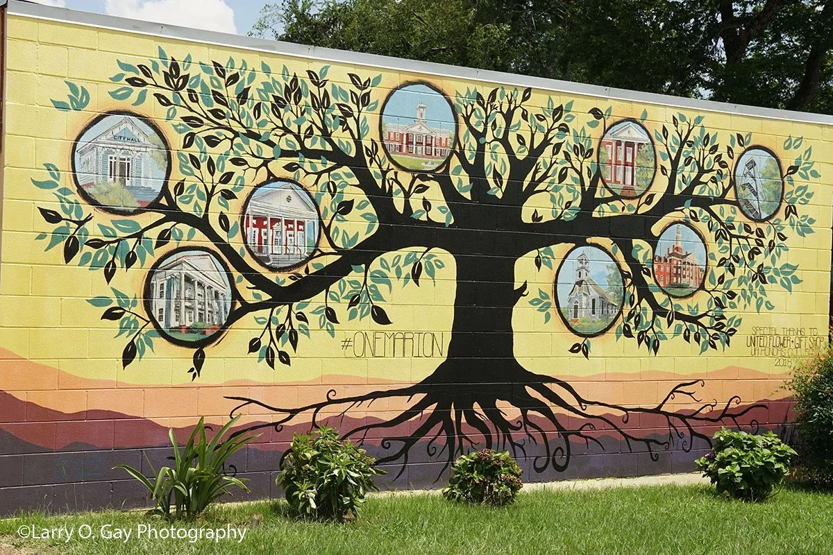 Tree mural with images of different historic buildings in Marion.