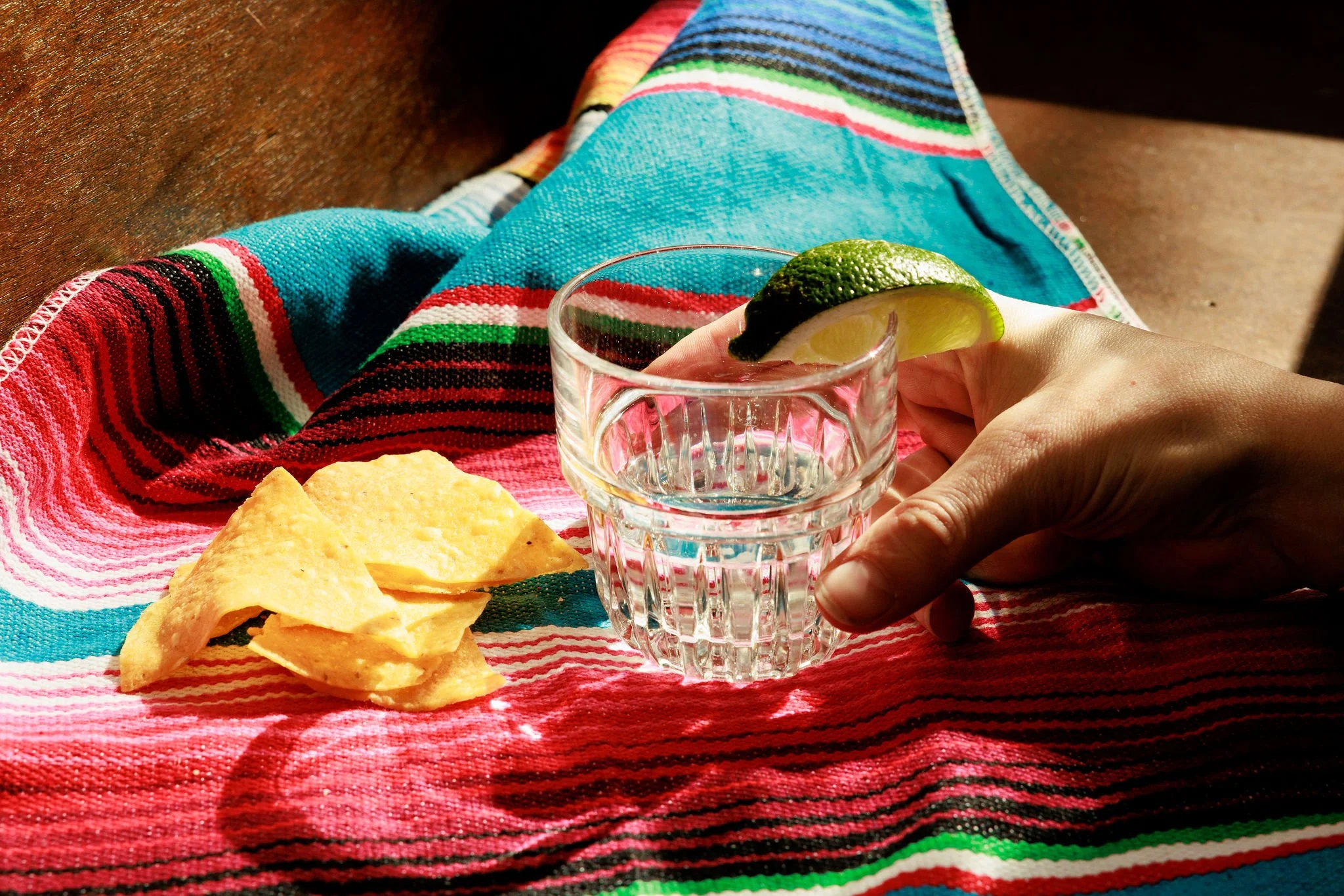 glass of tequila with chips