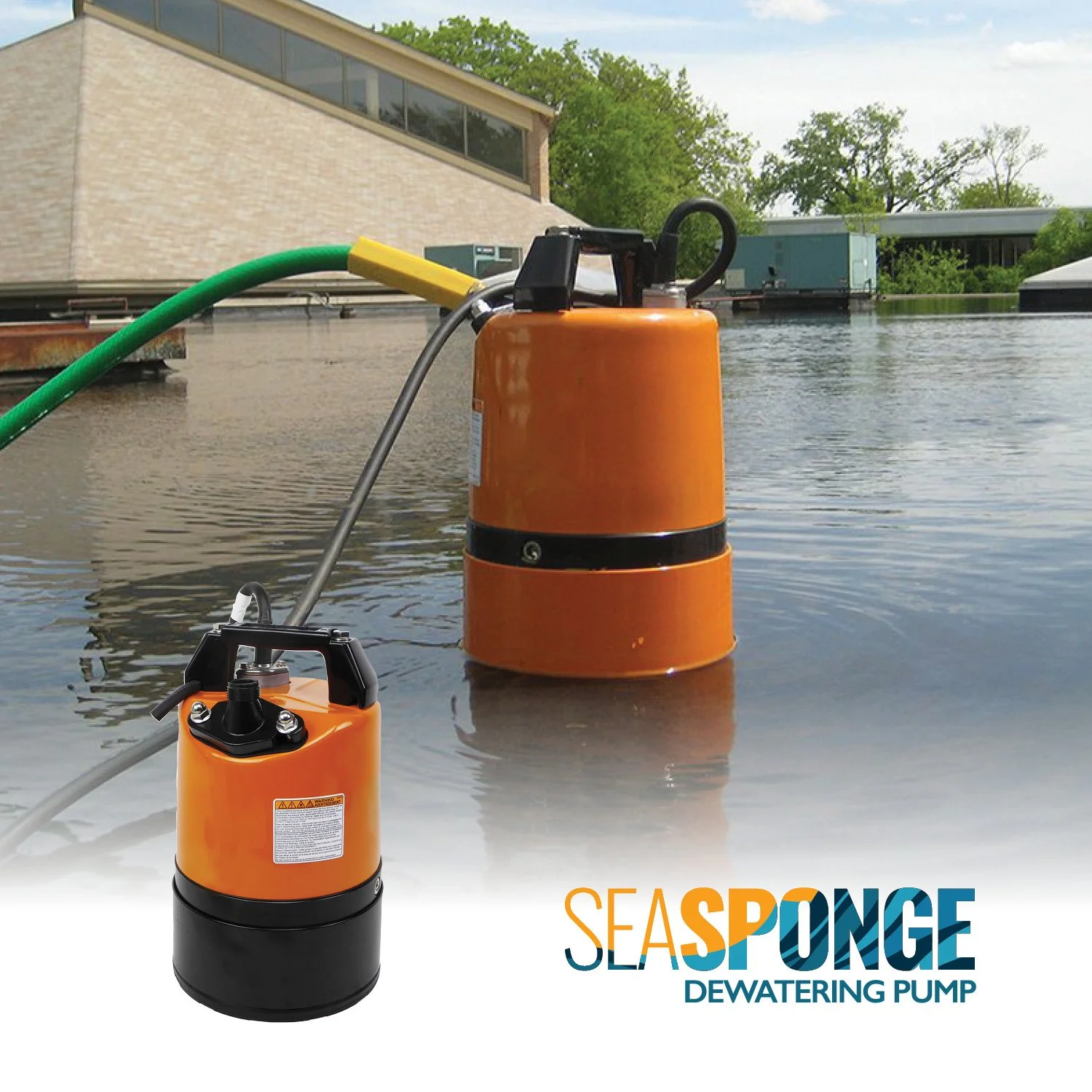 A sea sponge dewatering pump installed on a flooded outdoor surface with buildings and trees in the background.