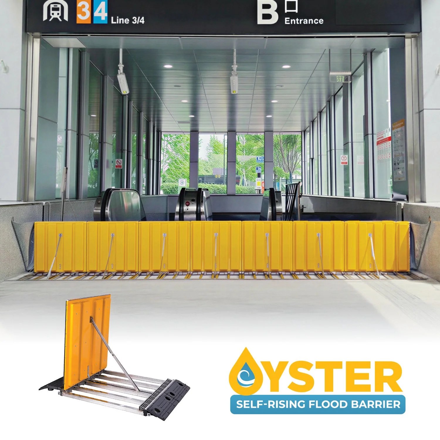 A self-rising flood barrier with yellow panels is installed at the entrance of a modern train station, with escalators and glass windows in the background.