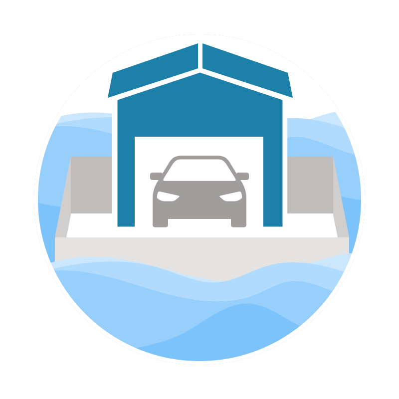 Car parked in an ice or snow storage facility surrounded by blue water.
