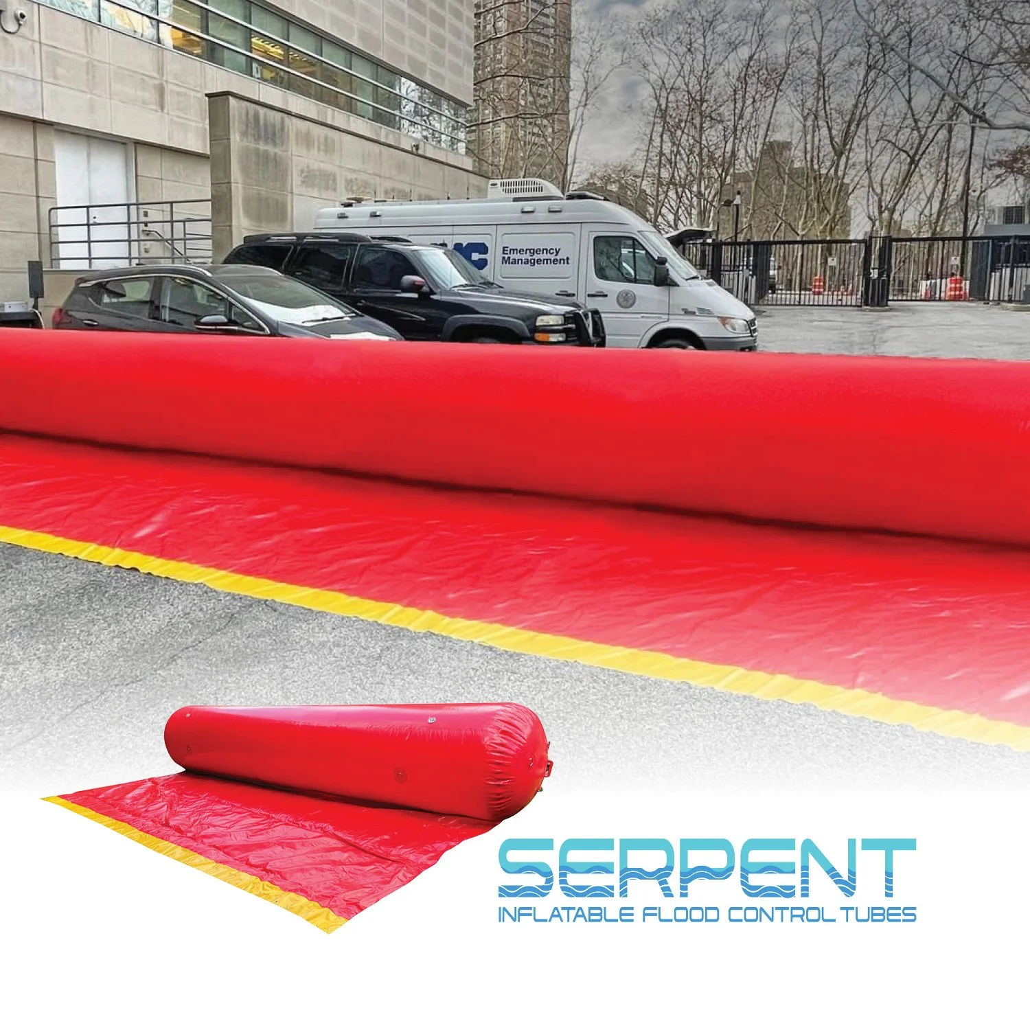 Red inflatable flood control tubes in an outdoor setting with a building, trees, and parked cars in the background.
