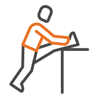 Person leaning forward at a desk, using a laptop
