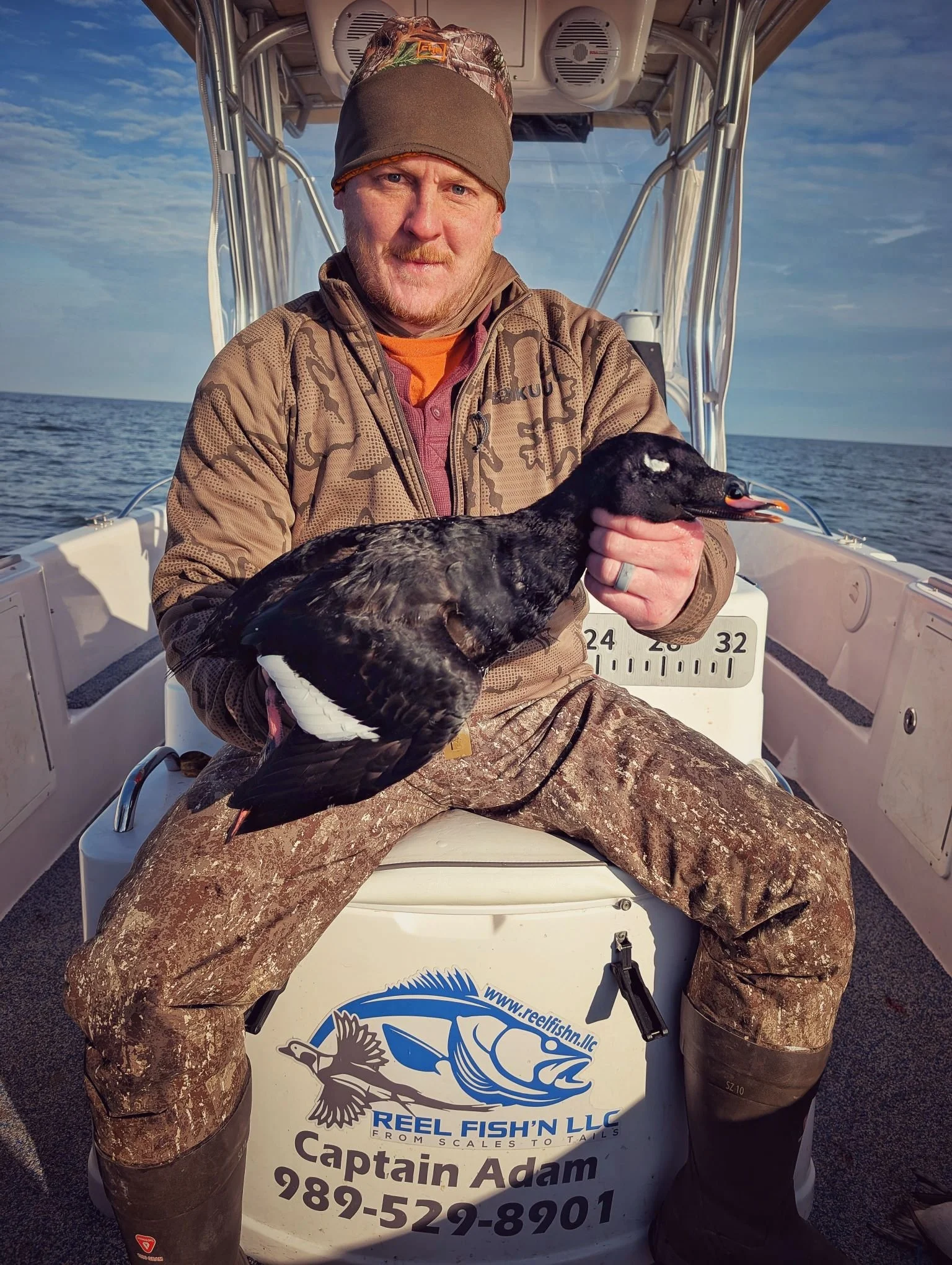 A customer layout boat duck hunting for Longtails on Lake Huron with Reel Fish'n LLC.