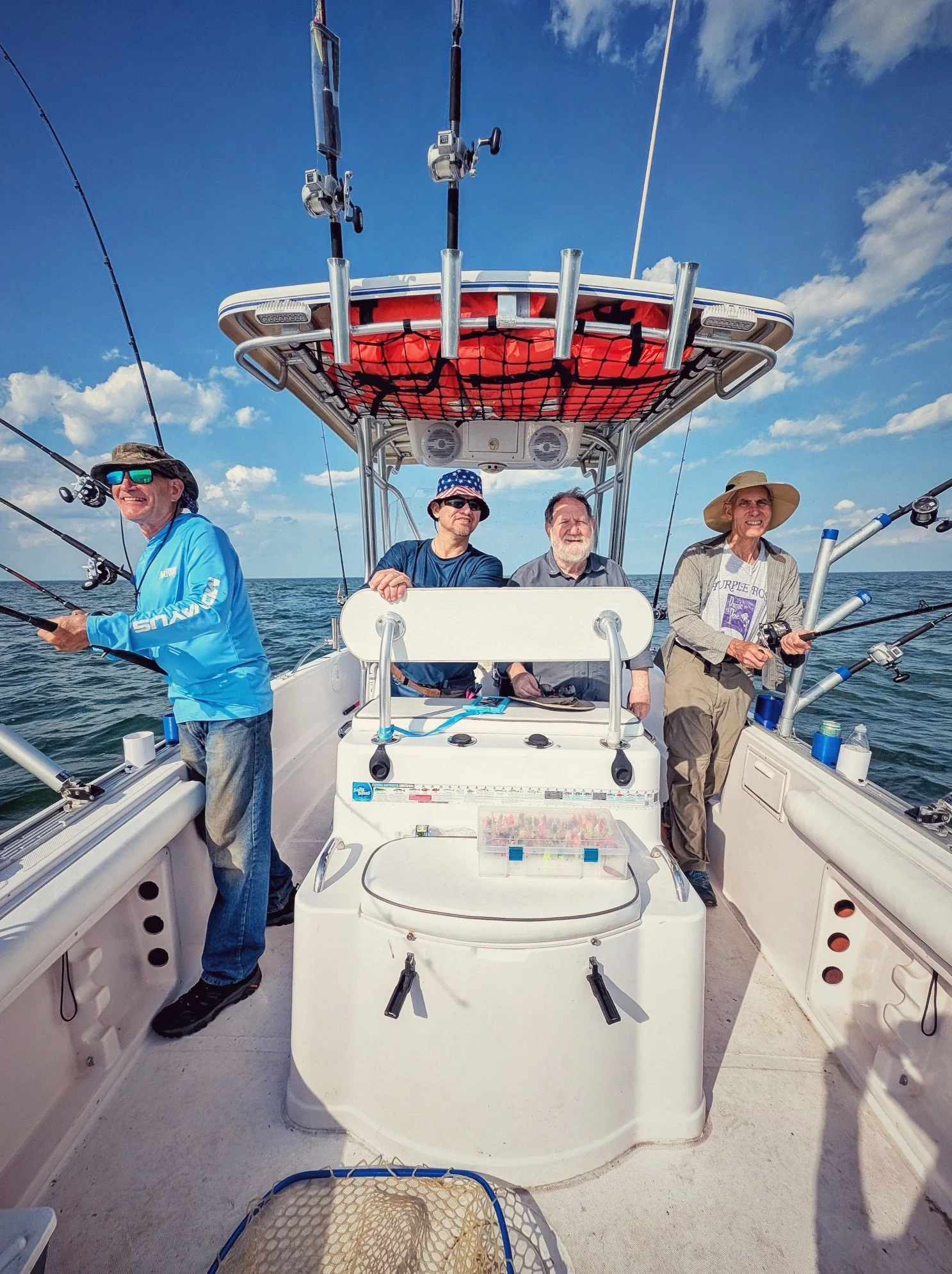  Clients enjoying a sunny day of trolling for walleye on a 25ft Proline center console Reel Fish'n charter boat on the open waters of Saginaw Bay. 