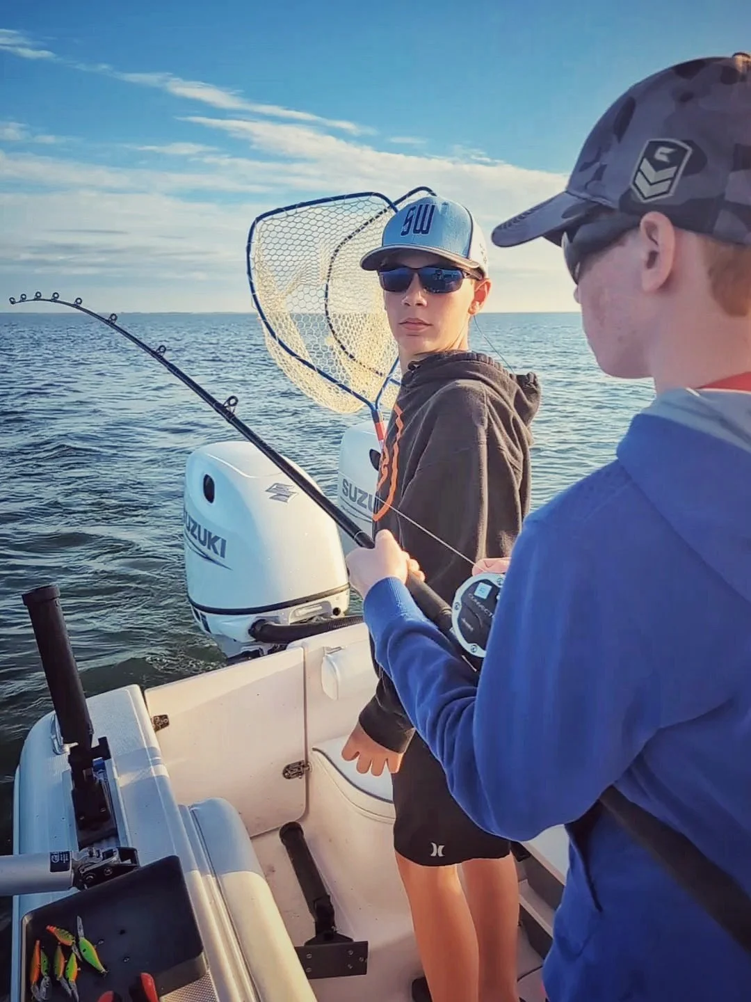  A young angler ready with the net to land a walleye while trolling on Saginaw Bay with Reel Fish'n LLC out of Linwood, Michigan. 