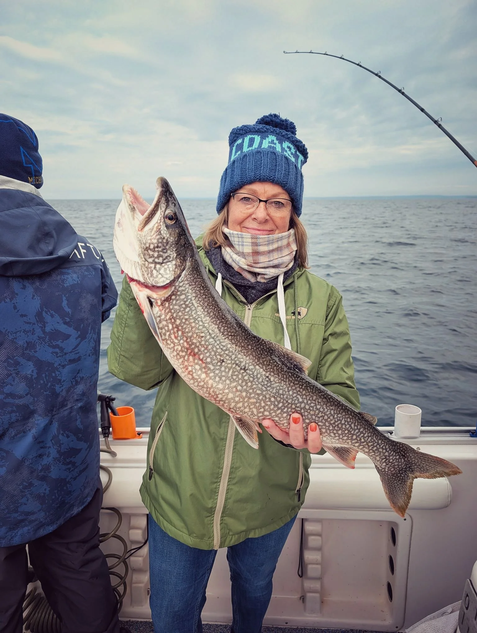  A female angler holding a large Lake Trout caught while fishing the DeTour Passage near Drummond Island during a Reel Fish'n LLC fall charter. 