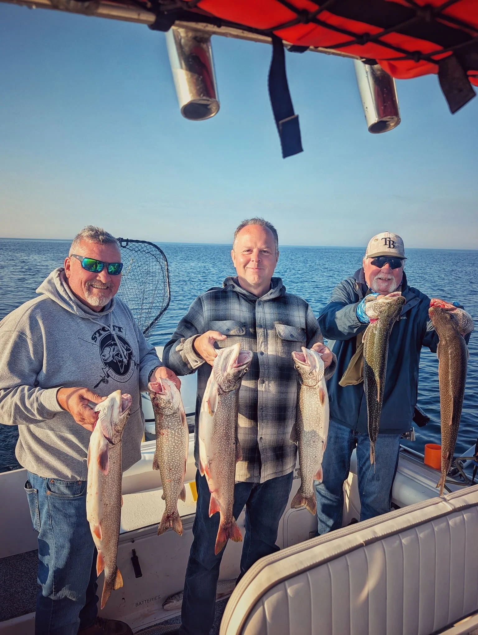  A group of happy anglers displaying a great catch of Lake Trout while fishing the DeTour Passage with Reel Fish'n, launching out of Drummond Island Yacht Haven.   