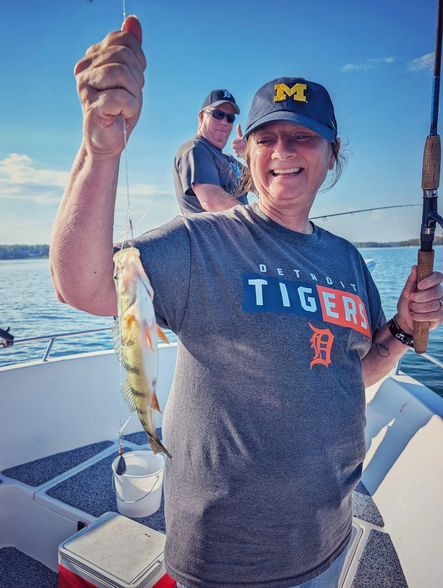 A female angler holding a fresh yellow perch during a fall morning on Drummond Island, launching from Drummond Island Yacht Haven with Reel Fish'n.   
