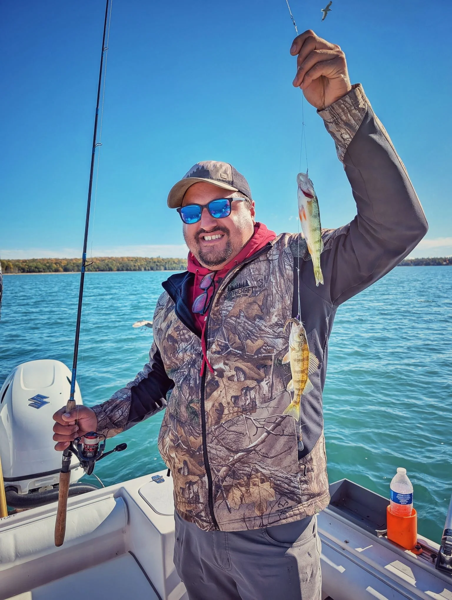  A happy fisherman showcasing a solid Drummond Island yellow perch caught during an October afternoon charter with Reel Fish'n. 