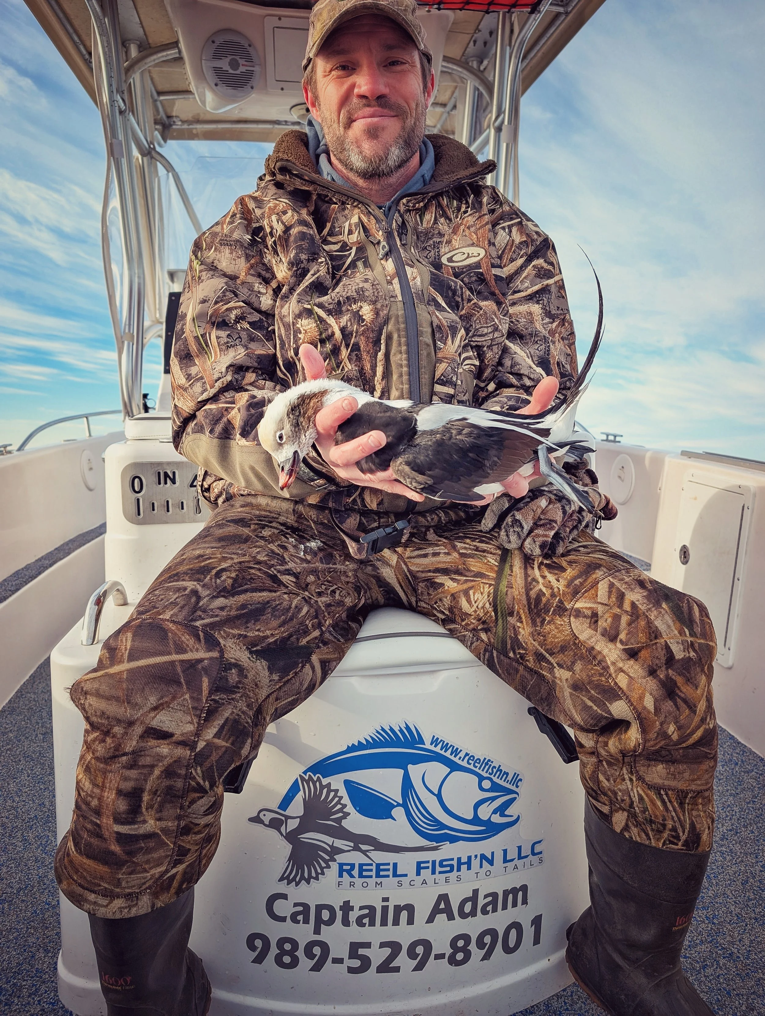  An angler showcasing a mature, trophy-grade Longtail (Old Squaw) shot during a specialized Great Lakes sea duck charter with Reel Fish'n LLC.   