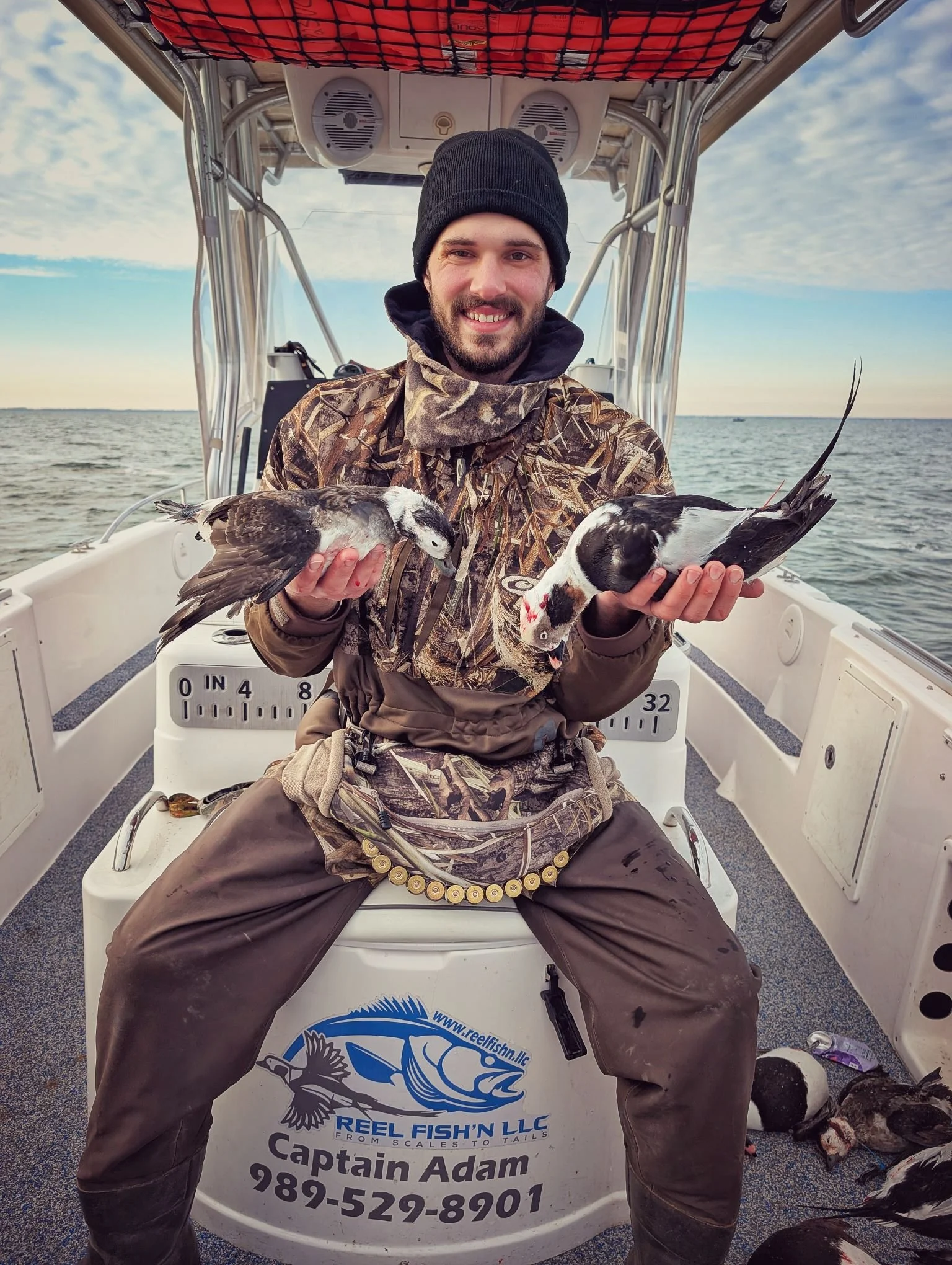  An angler showcasing a mixed bag of sea ducks, including Longtails and Scoters, shot from a layout boat on the Great Lakes with Reel Fish'n LLC.   