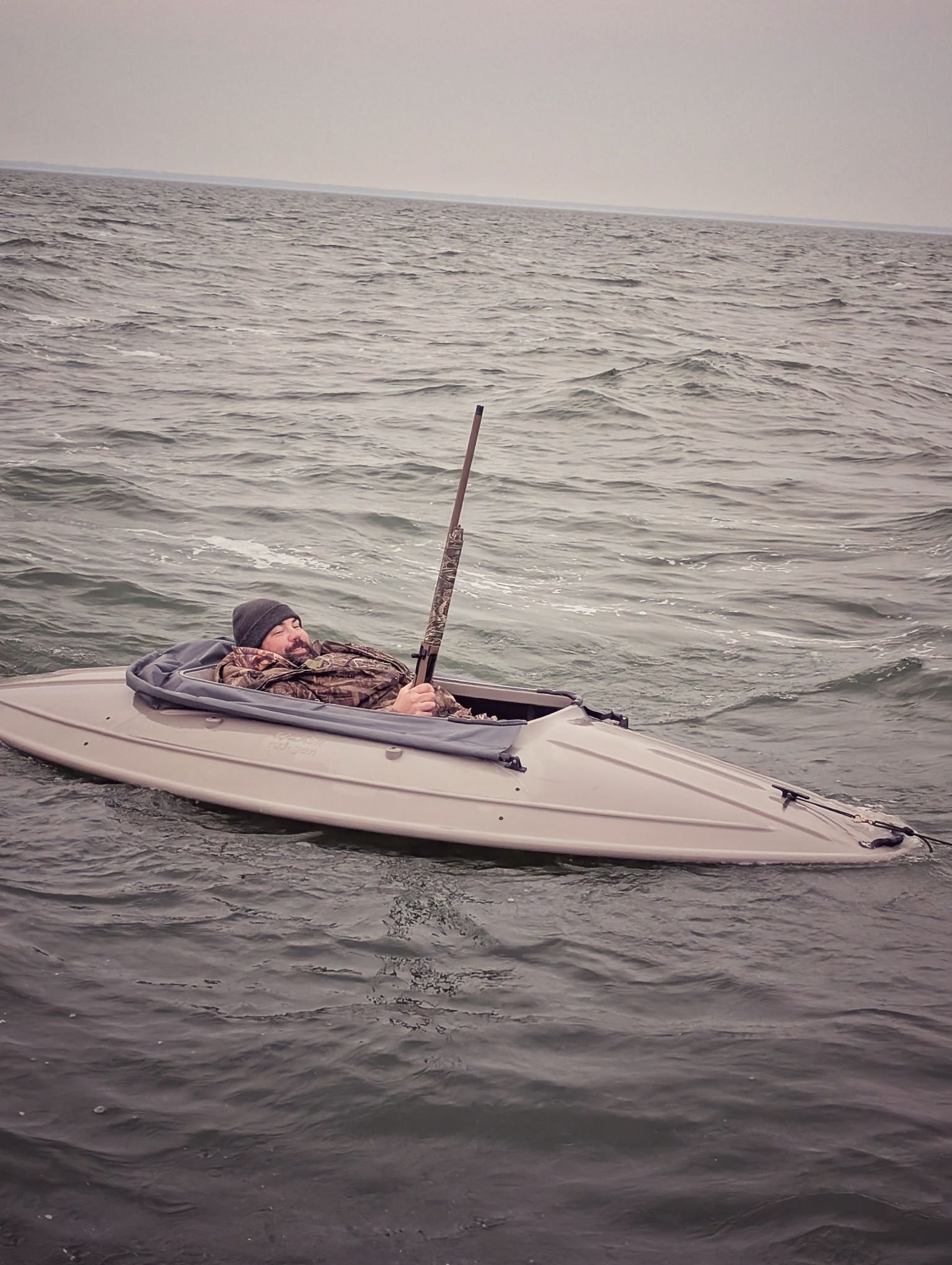  A hunter hunkered down in a Next Gen Kalash layout boat, disappearing into the waves to hunt Longtails (Old Squaw) on the open water of Lake Huron.   