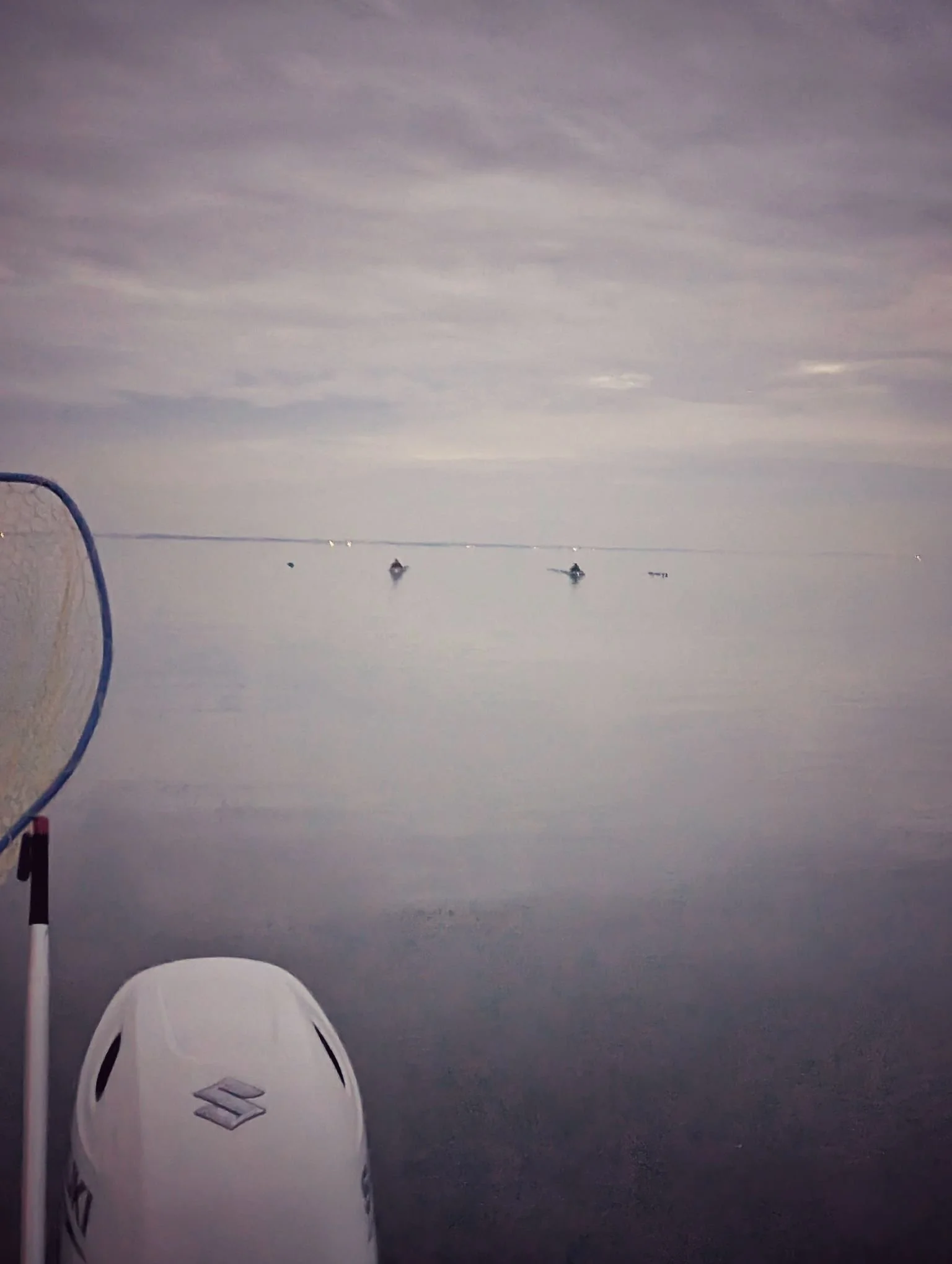  Layout boats disappearing into a foggy morning on Lake Huron; the perfect low-visibility conditions for targeting wary sea ducks on the open water.   