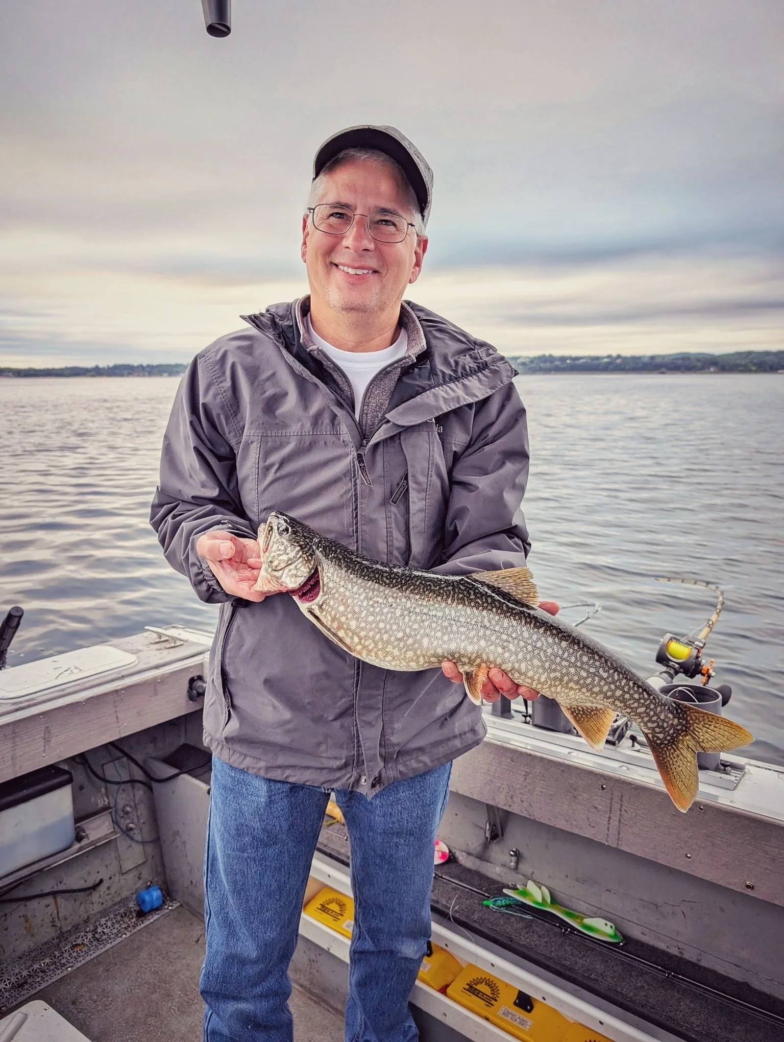 A successful client displaying a solid Lake Trout caught while trolling the deep waters of Grand Traverse Bay with Reel Fish'n.   