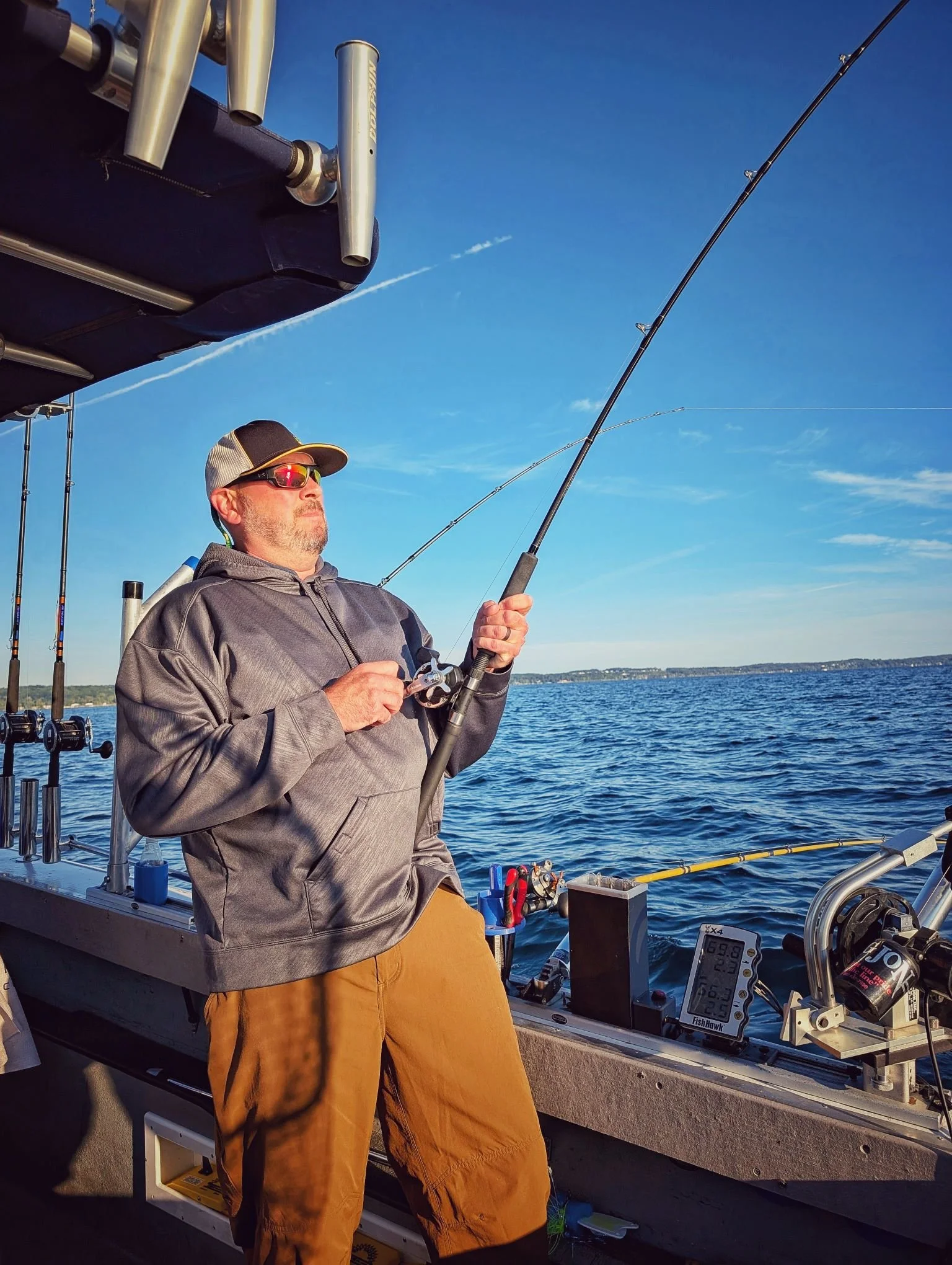  An angler battling a heavy King Salmon during the limited late-summer run on Grand Traverse Bay with Reel Fish'n.   