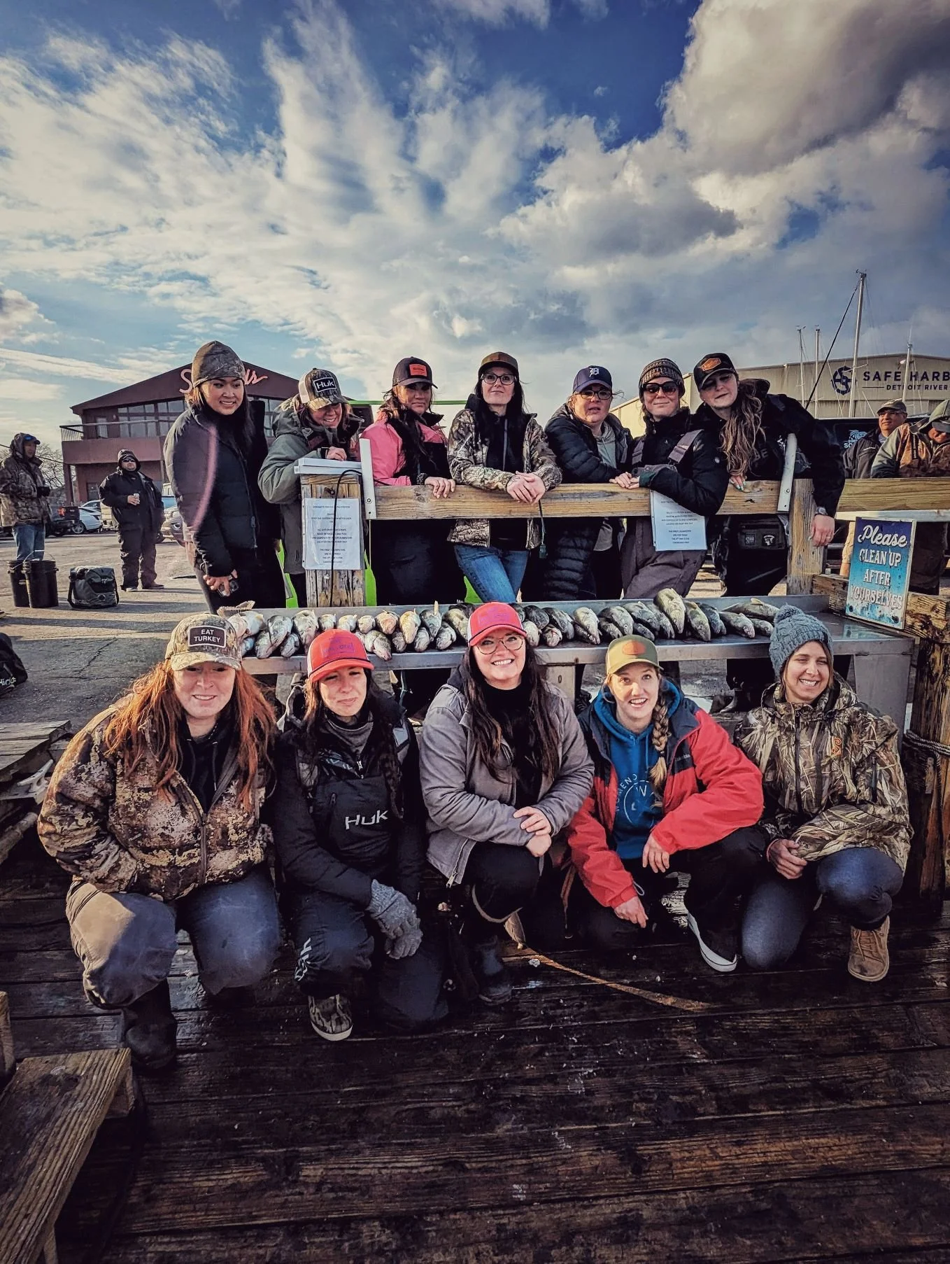  A large group of female anglers posing with a heavy limit of spring walleye on the Detroit River docks with Reel Fish'n LLC.   