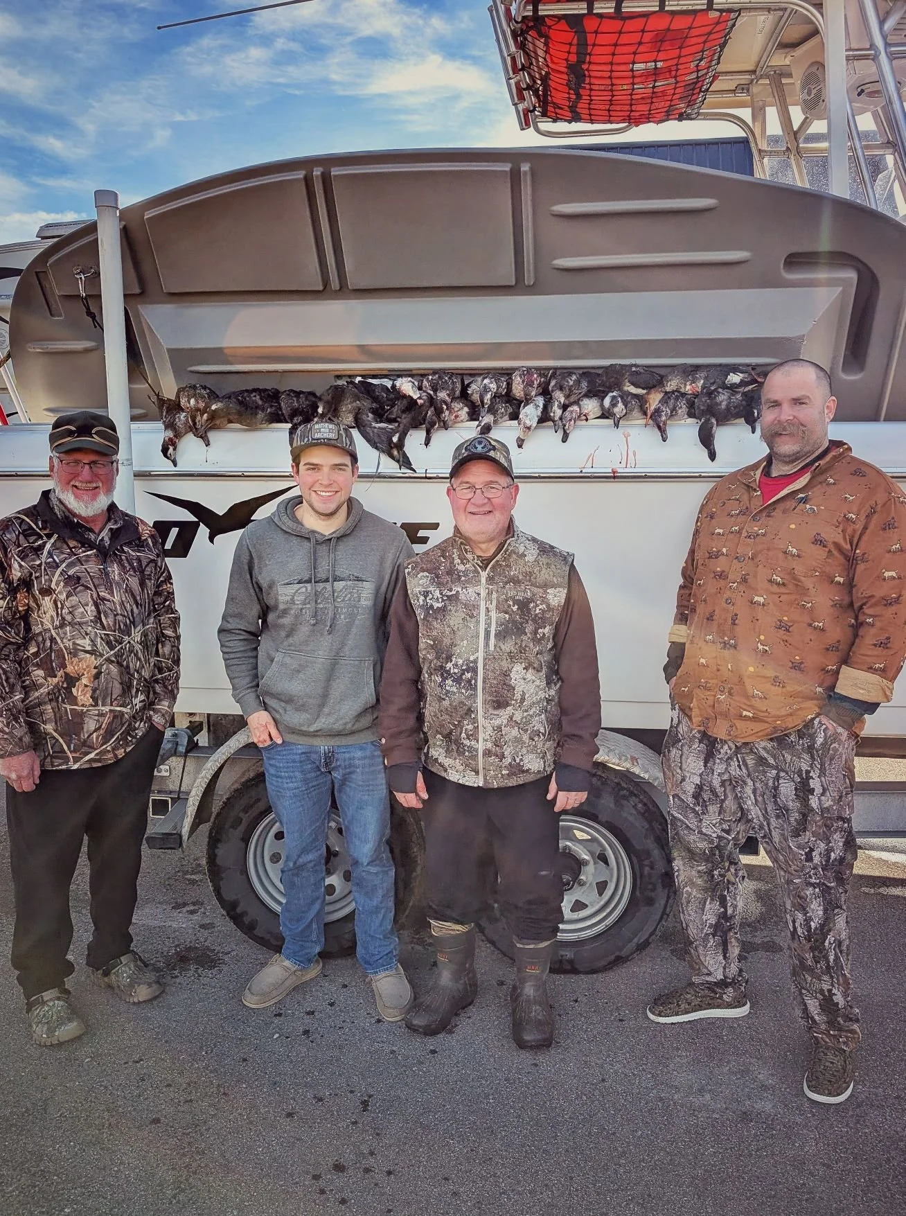 Generations of hunters celebrating a successful day on the Great Lakes, proving that layout boat hunting is an experience for everyone.