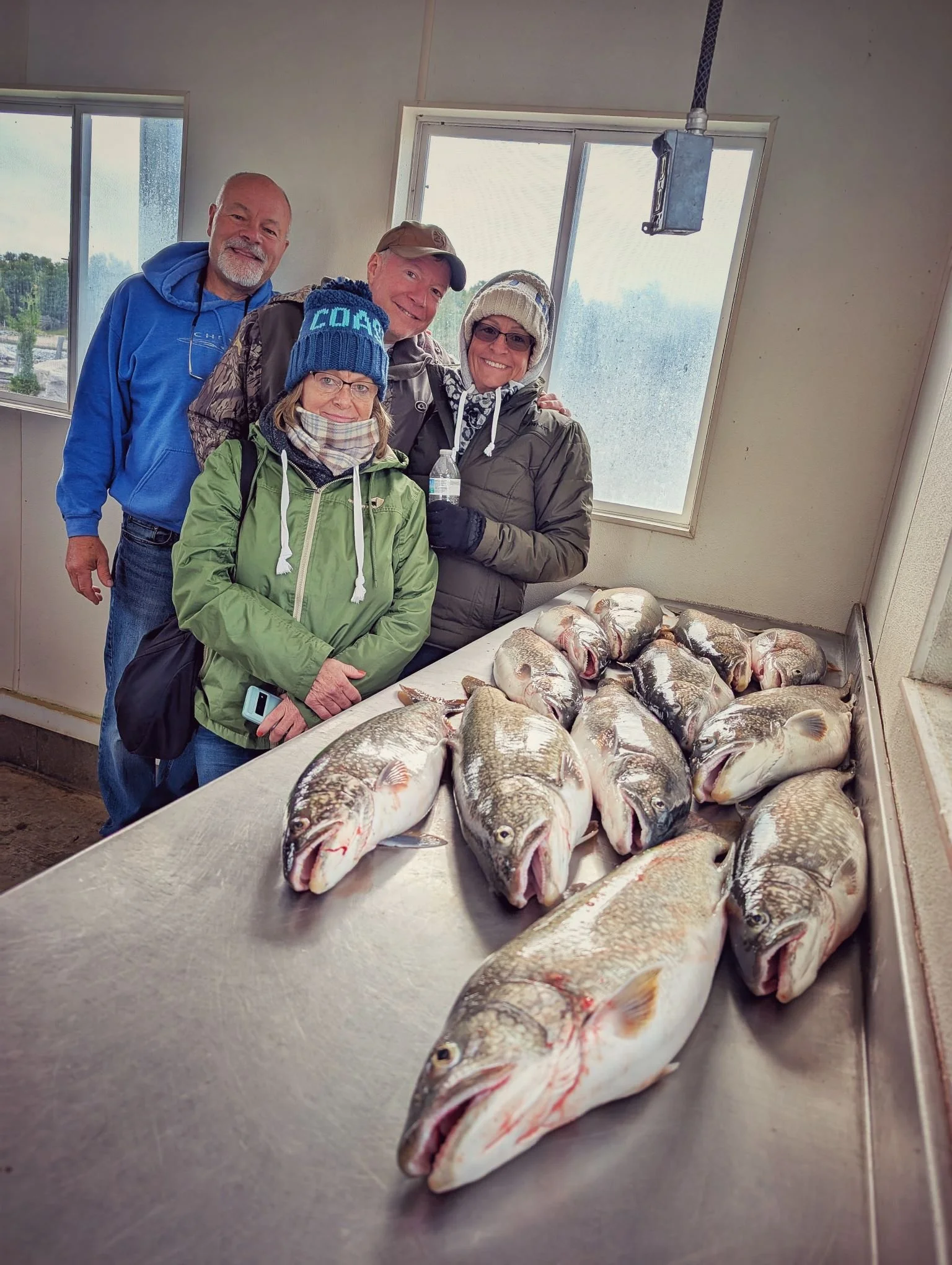 A group of happy anglers with a heavy limit of Lake Trout and Salmon caught in the DeTour Passage during a Reel Fish'n fall charter out of Drummond Island Yacht Haven.