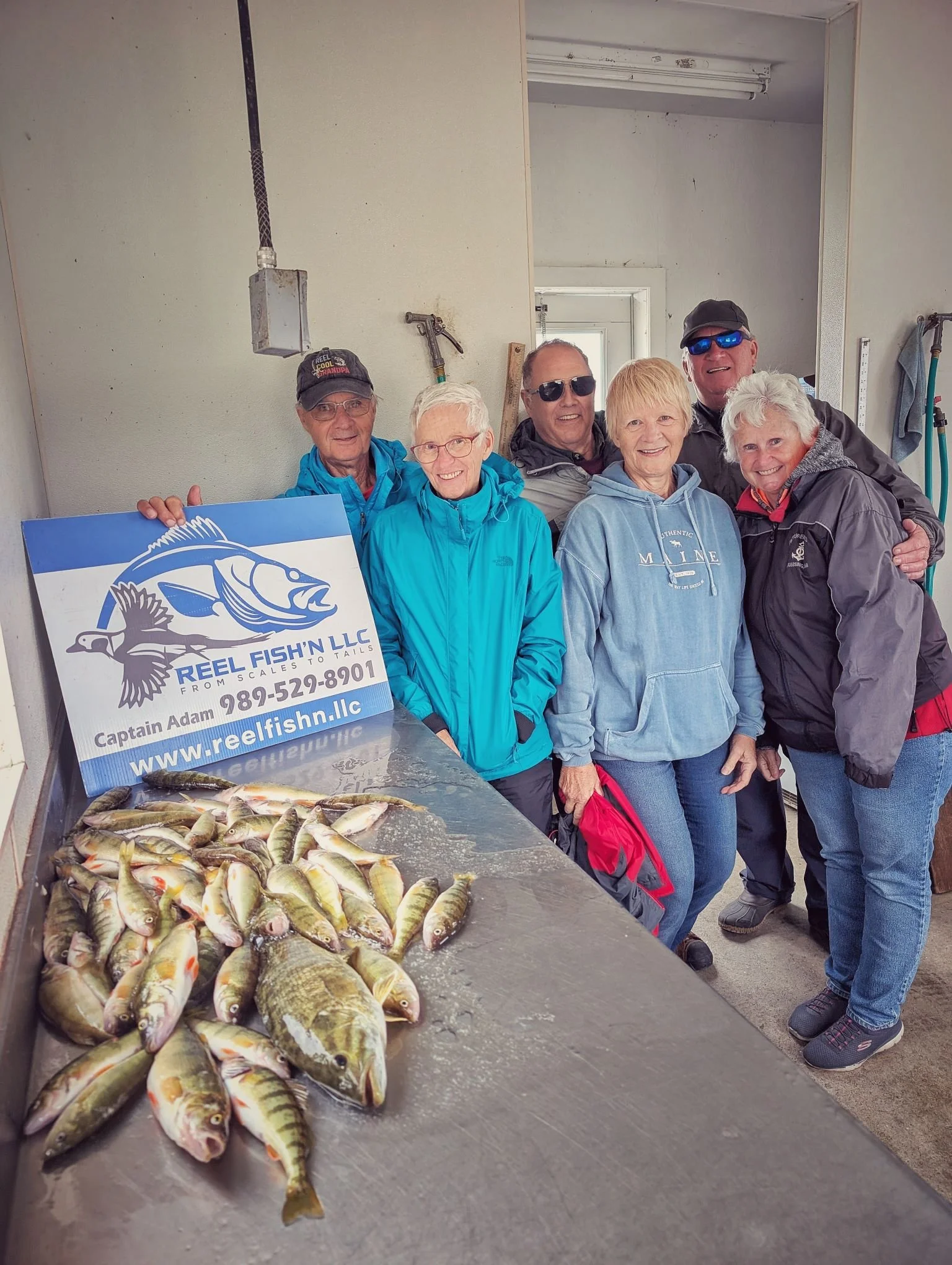 A group of ladies celebrating a successful morning of perch fishing on Drummond Island during the peak of the fall season with Reel Fish'n LLC.
